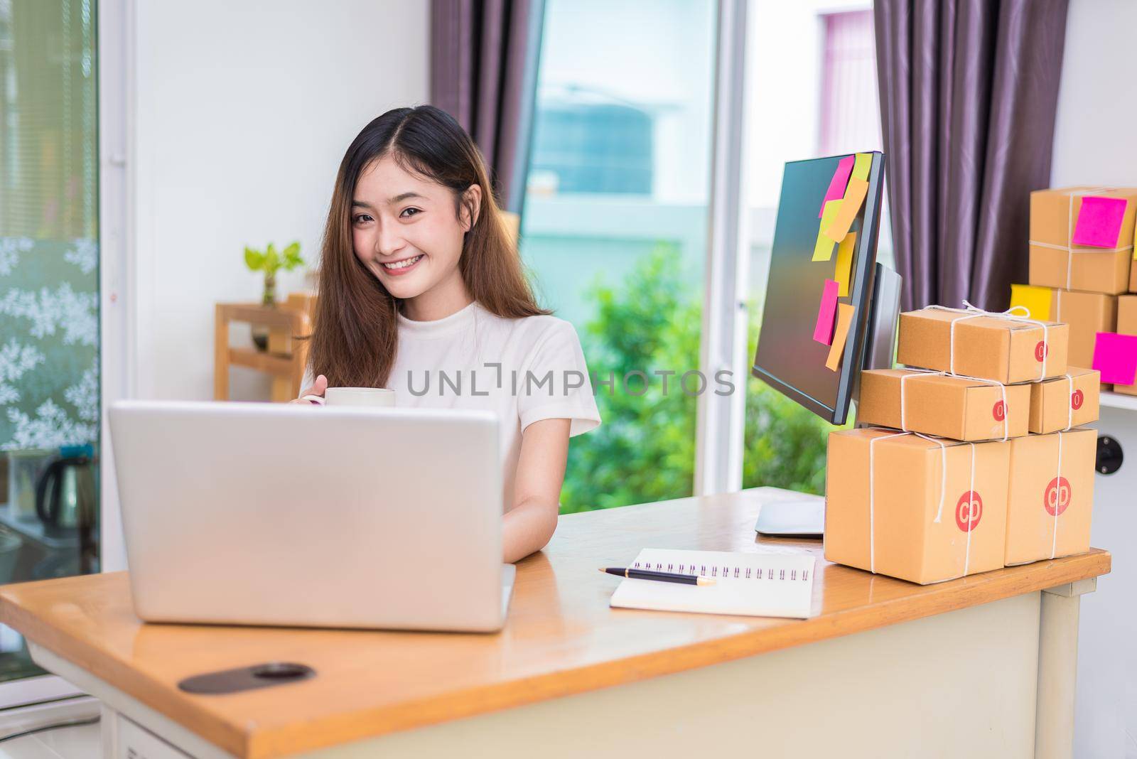 Asian woman enjoy herself while using laptops and internet in office. Business and marketing and part time concept. On line shopping and business success theme. Happy mood doing working job.