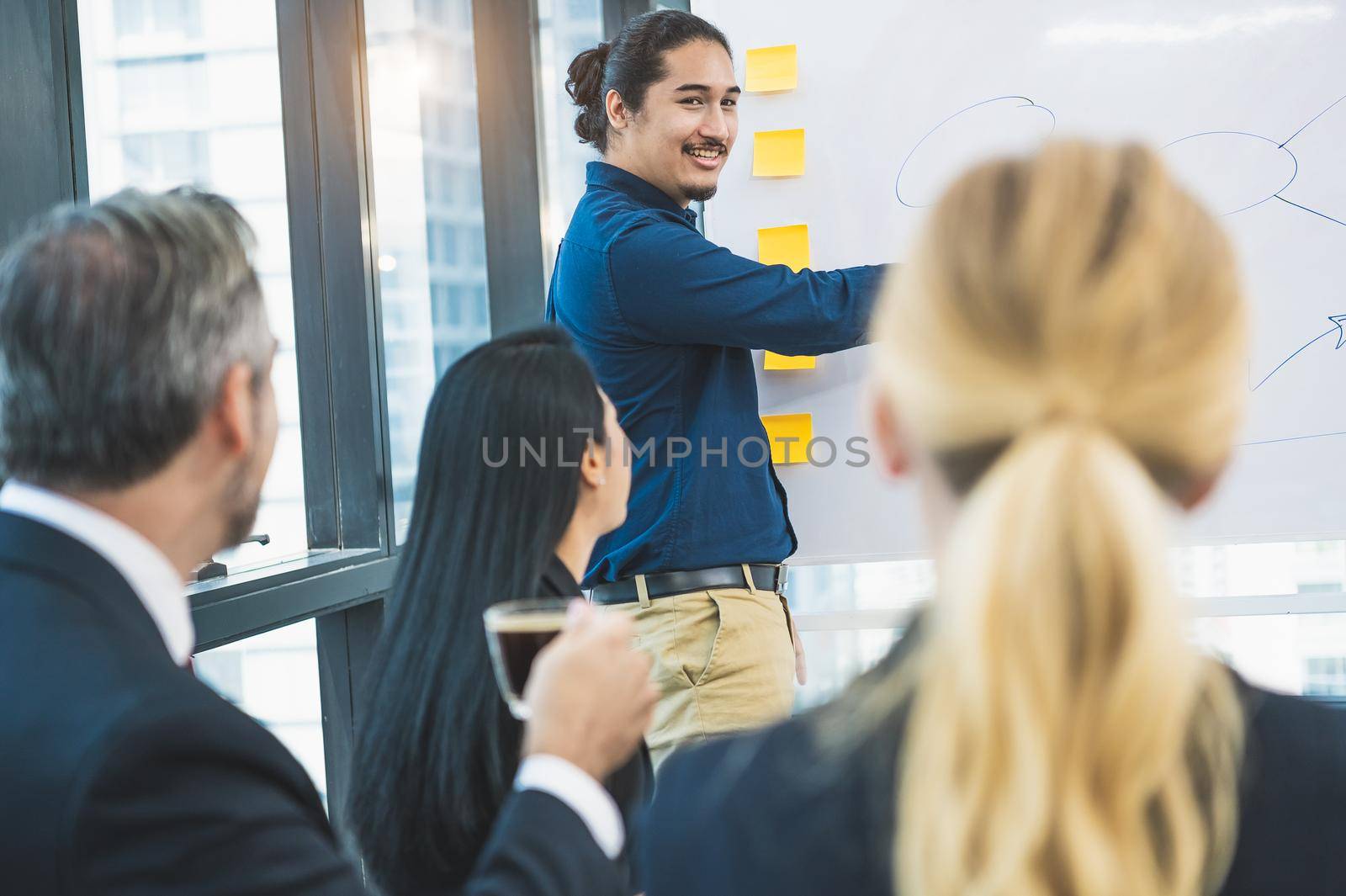 Business people group listened to the instructors explaining about the marketing strategy according to the budget plan in office. Business team meeting together and discussing for startup new project.
