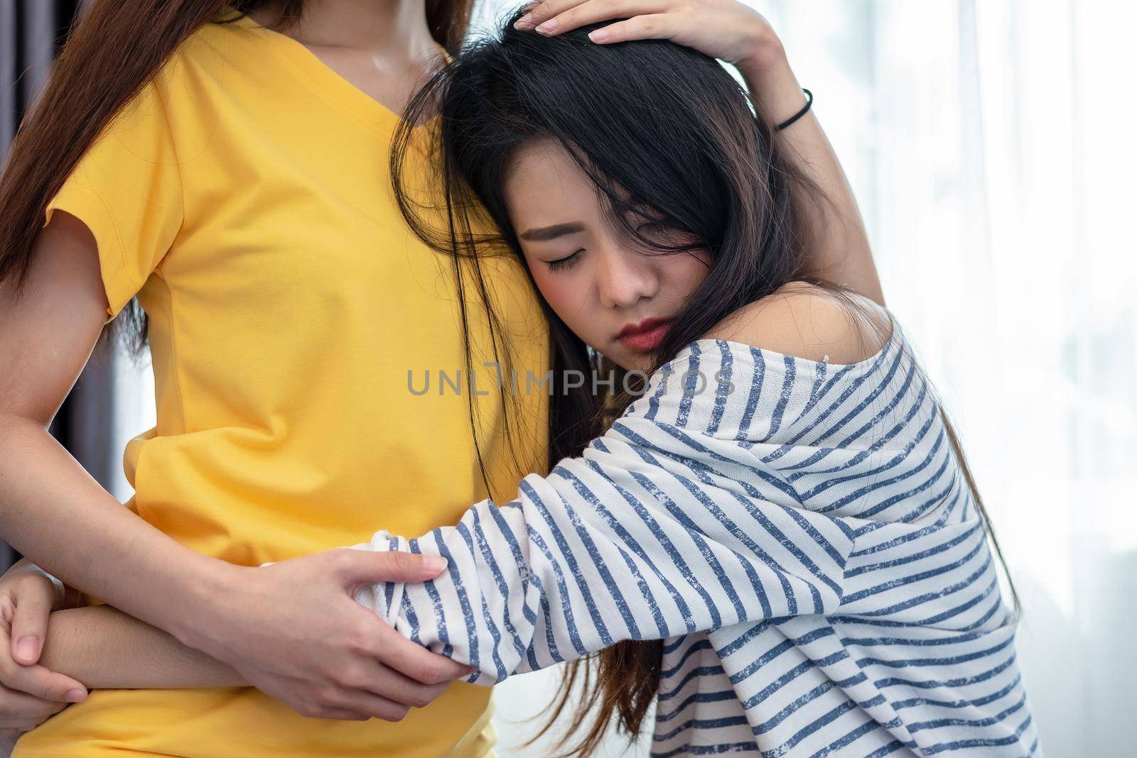 Asian beauty sad girl was comforted by a girl friend. People and social issues problem concept. Lifestyle and Friendships theme. Lesbian and family theme.