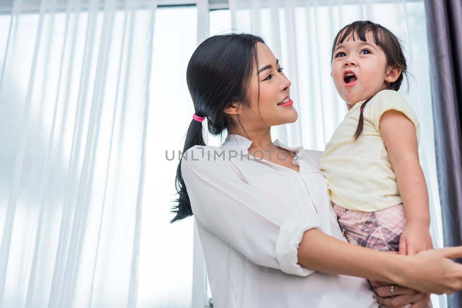 Portrait of Asian mother and cute daughter in bed room. Back to school and Education concept. Children and kids theme. Home sweet home and Nursery theme.