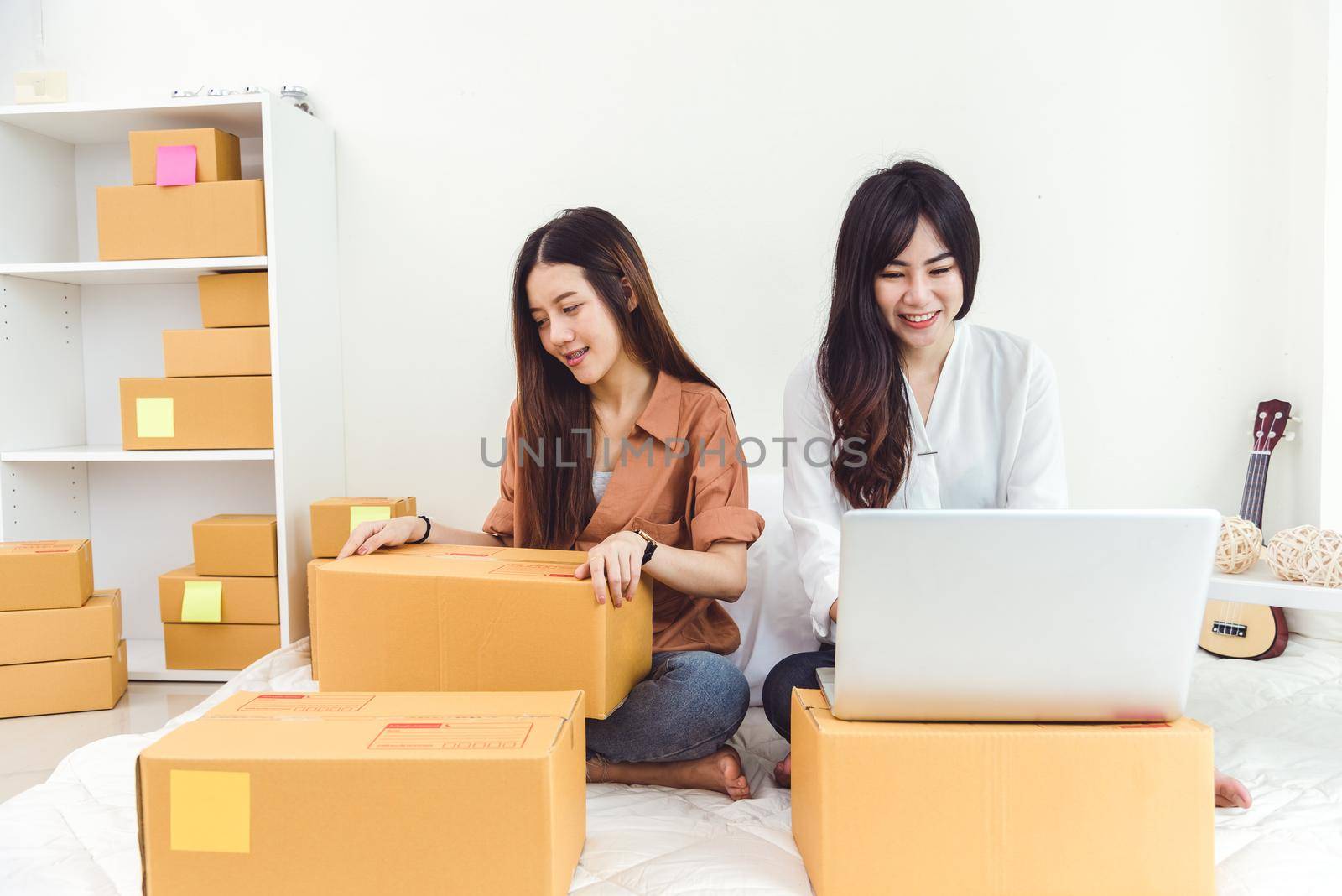 Young Asian woman startup small business entrepreneur SME distribution warehouse with parcel mail box. Owner home office concept. Online marketing and product packaging and delivery service.