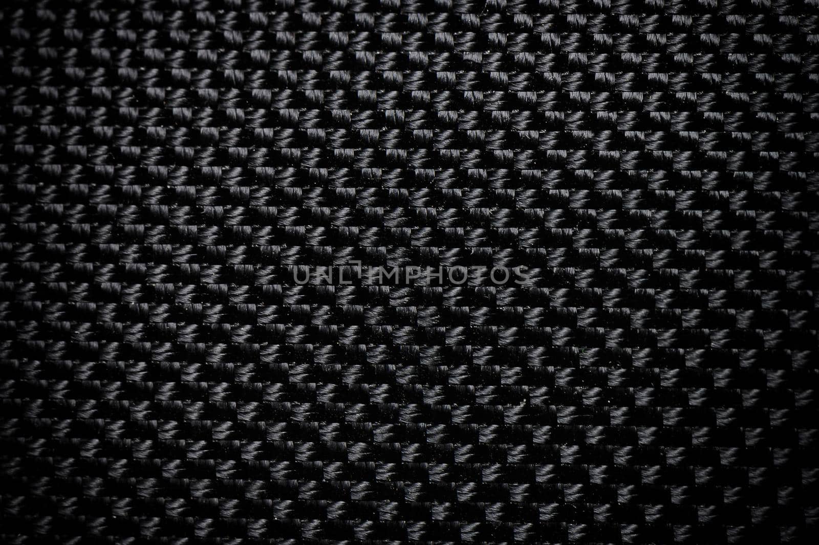 Black fabric canvas silk texture background. Abstract closeup detail of textile material wallpaper.