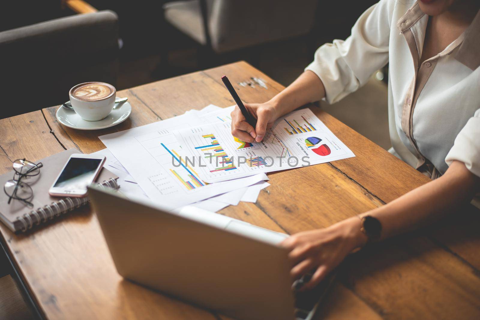 Close up of business woman working with documents and laptop in office. Business and Lifestyles concept. Entrepreneur and Freelance theme.