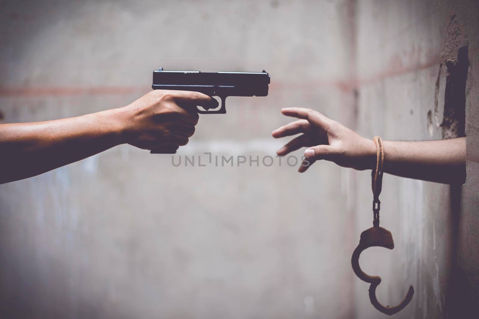 Escaped prisoner with a police gun. Breakaway prisoner and Police concept, Prohibited Law and Rule concept. Cross processing and split tone pinterest and instragram like process.