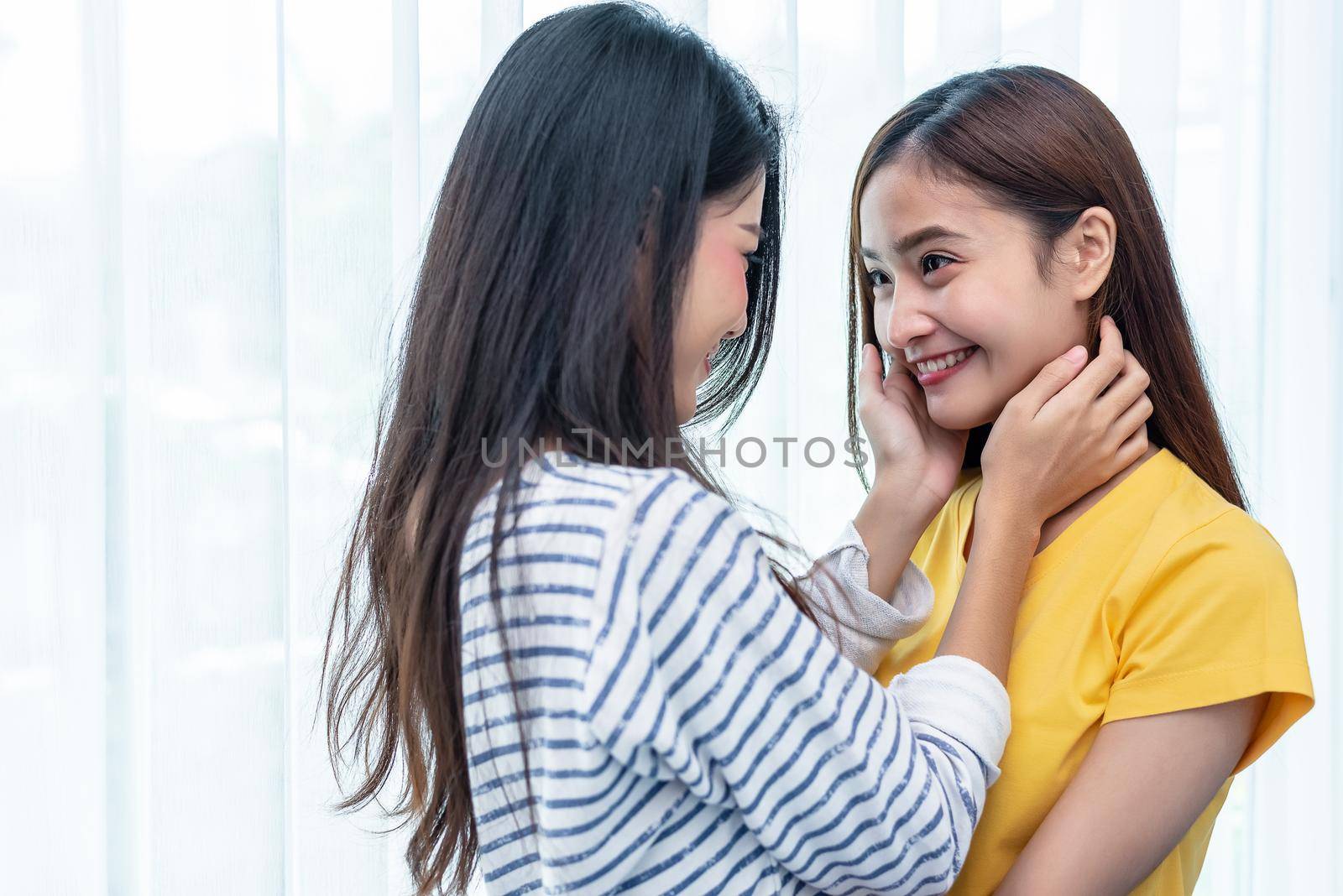 Two Asian women looking at each others in home. People and lifestyles concept.  LGBT pride and lesbian theme.