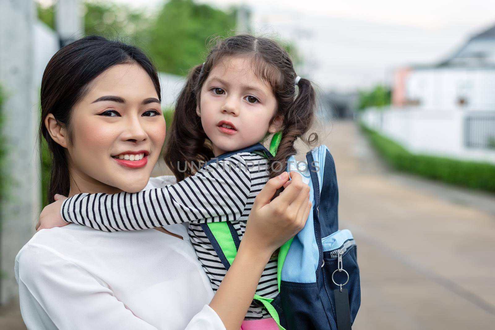 Mom and her daughter portrait together before going to school. Back to school and Education concept. Home sweet home and happy family theme.