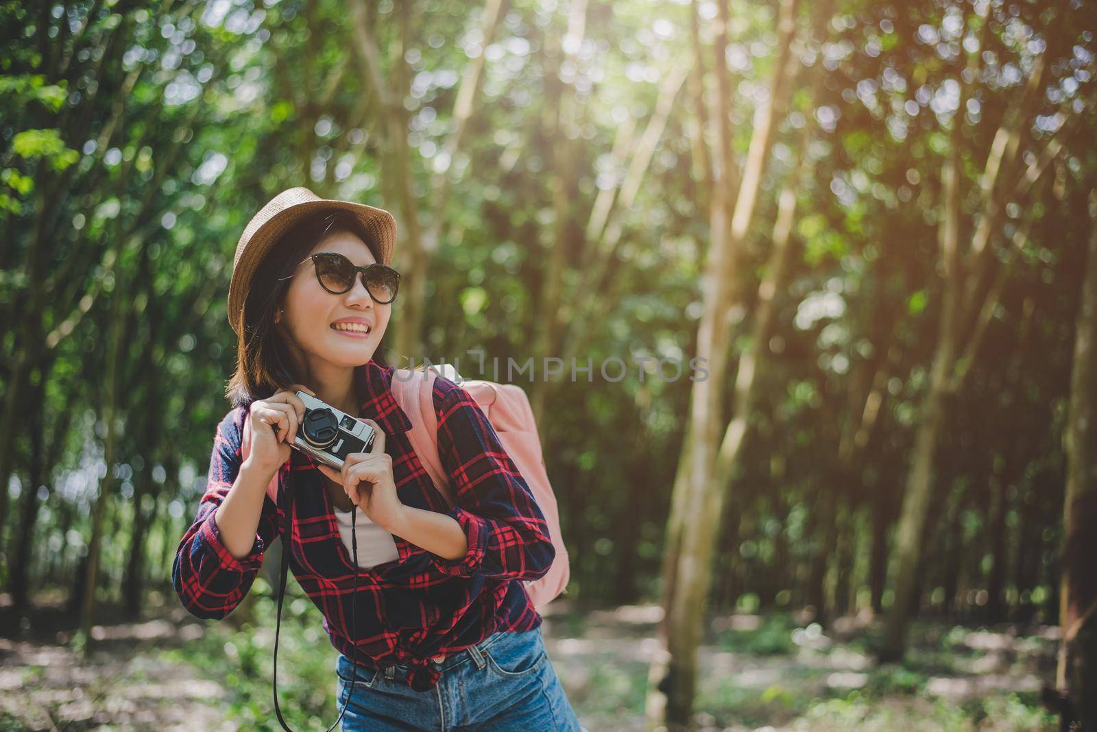Beauty Asian woman smiling lifestyle portrait of pretty young woman having fun in outdoors summer with digital camera. Traveling of photographer concept. Hipster style and Solo woman theme. by MiniStocker