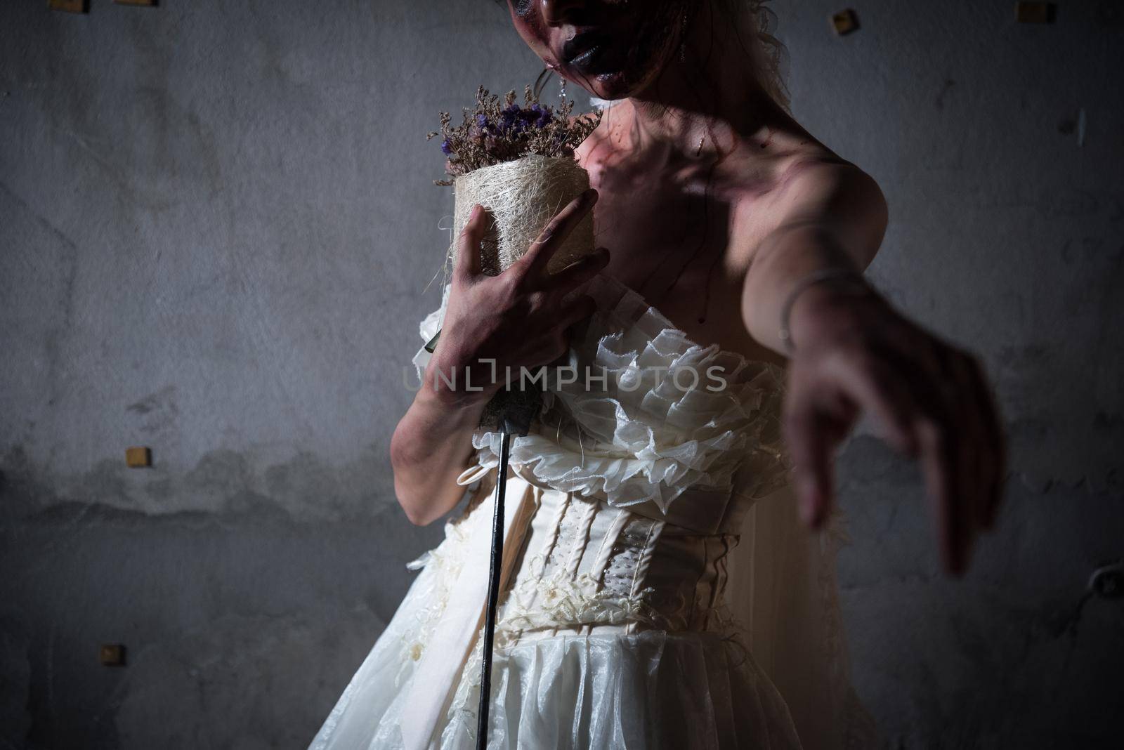 Bride Zombie in wedding dress with dried flowers pointing and want you to stay with her in abandoned house, Halloween theme, Ghost and deadman concept, Heart broken and neglected concept, Dark tone by MiniStocker