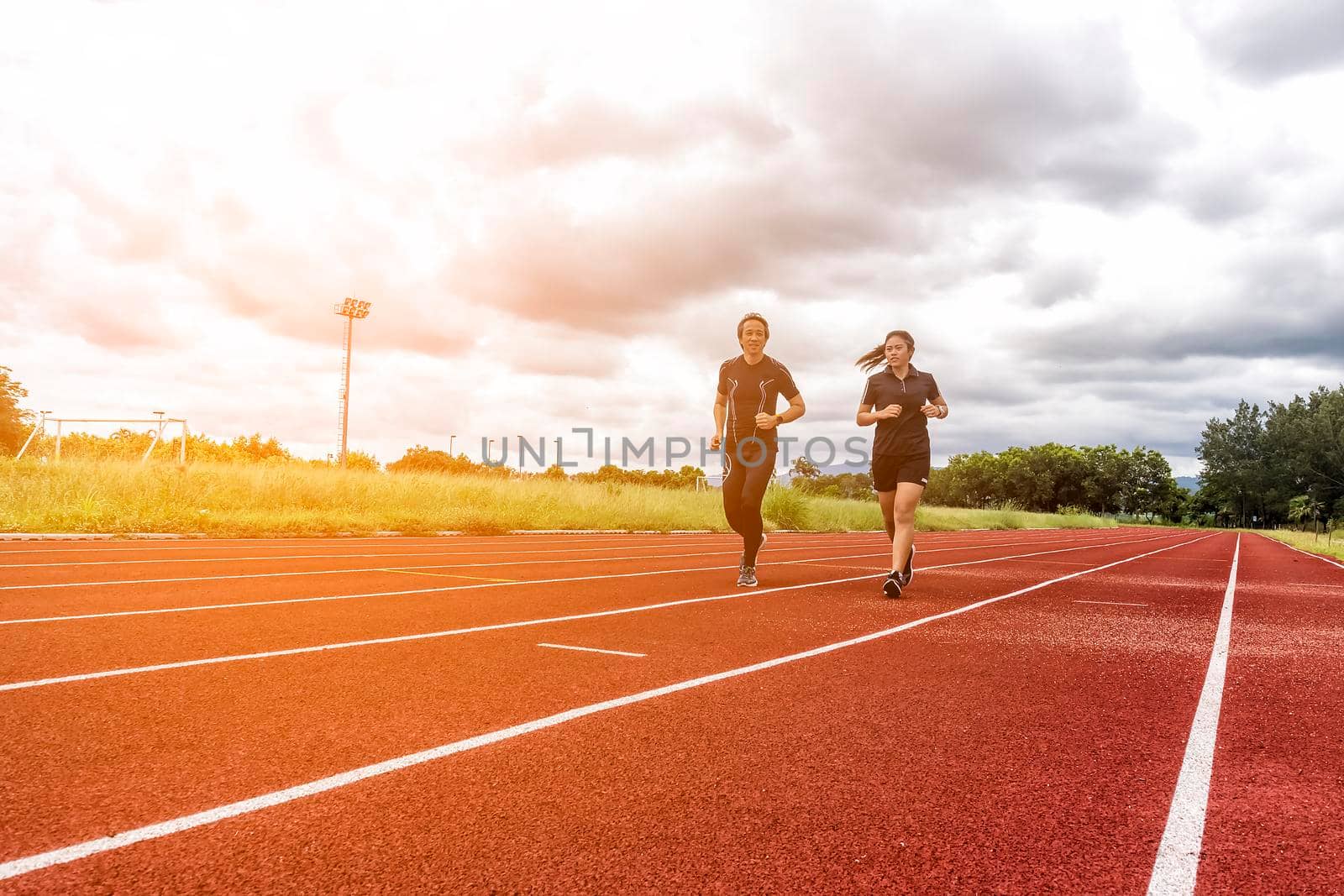 Two runners jogging on the race track, Sport and Social activity concept