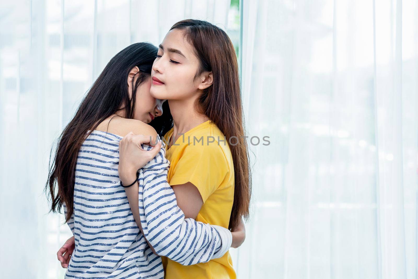 Two Asian Lesbian women looking together in bedroom. Couple people and Beauty concept. Happy lifestyles and home sweet home theme. Embracing of homosexual. Love scene making of female