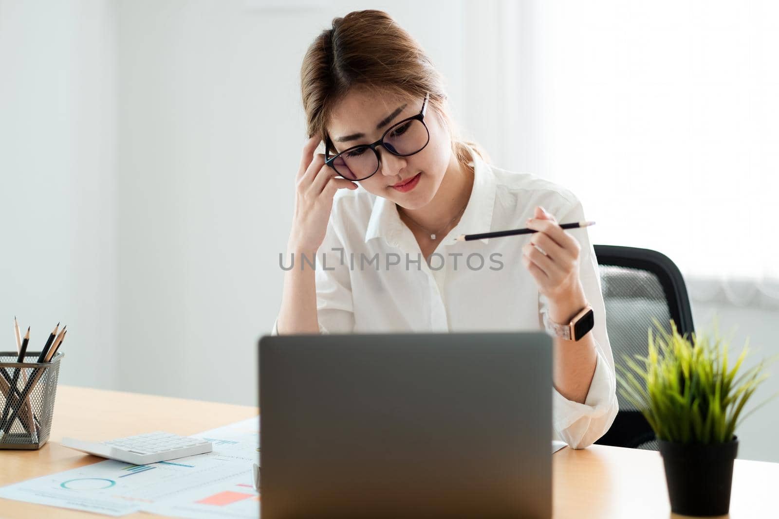 Woman accountant working financial inspector and secretary making report calculating balance. Internal Revenue Service checking document. Audit concept by nateemee