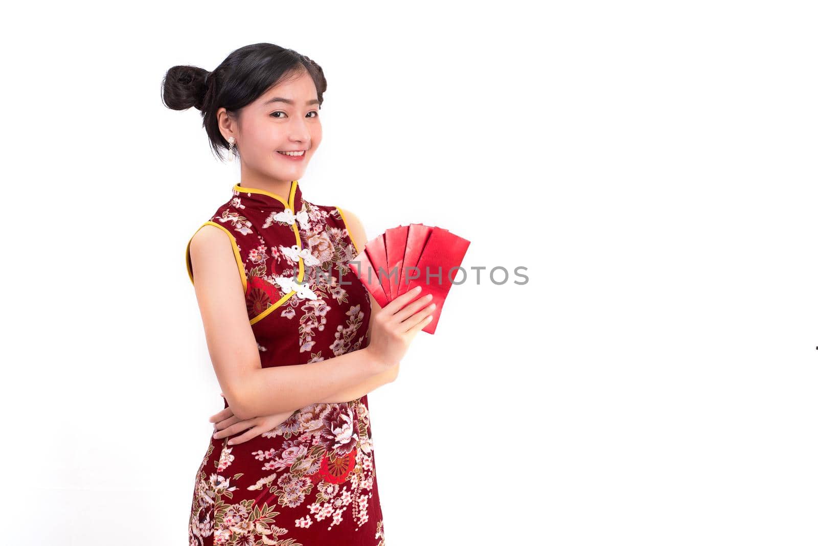 Young Asian beauty woman wearing cheongsam and holding packet of moneys gesture in Chinese new year festival event on isolated white background. Holiday and Lifestyle concept. Qipao dress wearing