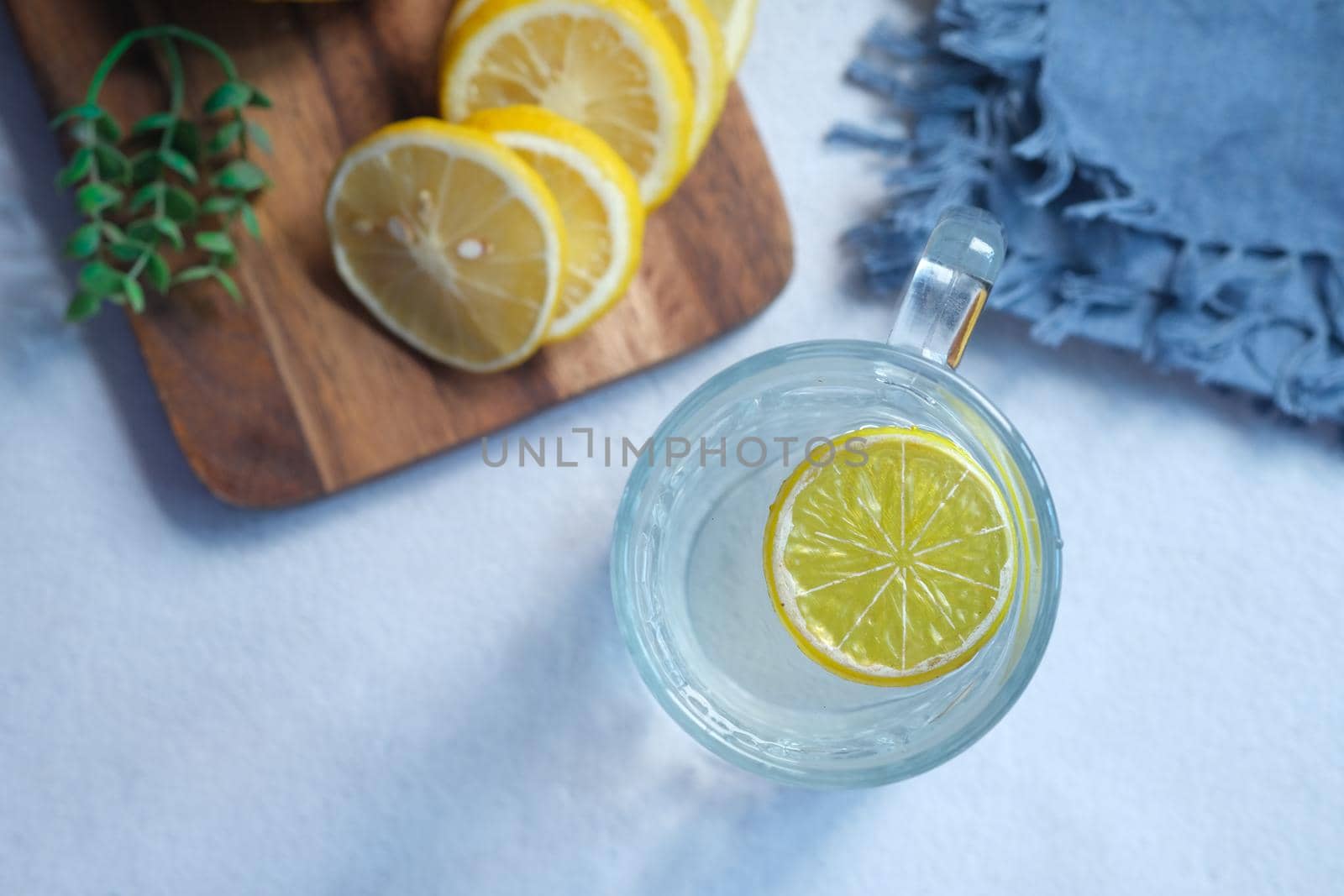 Refreshing lemon water drink on table , top view .