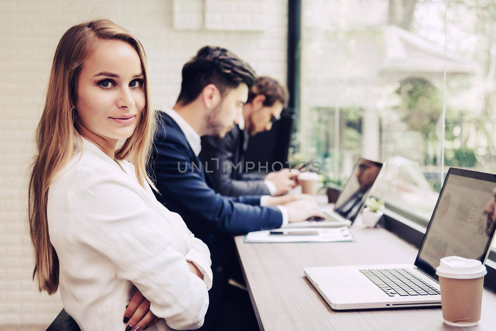 Business woman working with business team by laptop computer. Beauty and Technology concept. Smart lady and working woman theme. Office and happy life theme.