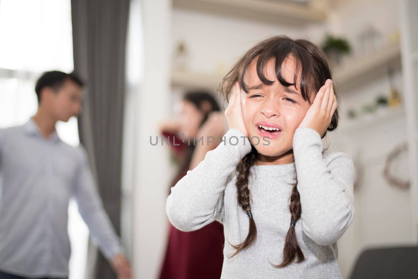 Little girl was crying because dad and mom quarrel, Sad and dramatic scene, Family issued, Children's Rights abused in Early Childhood Education and Social and parrents care problem concept by MiniStocker