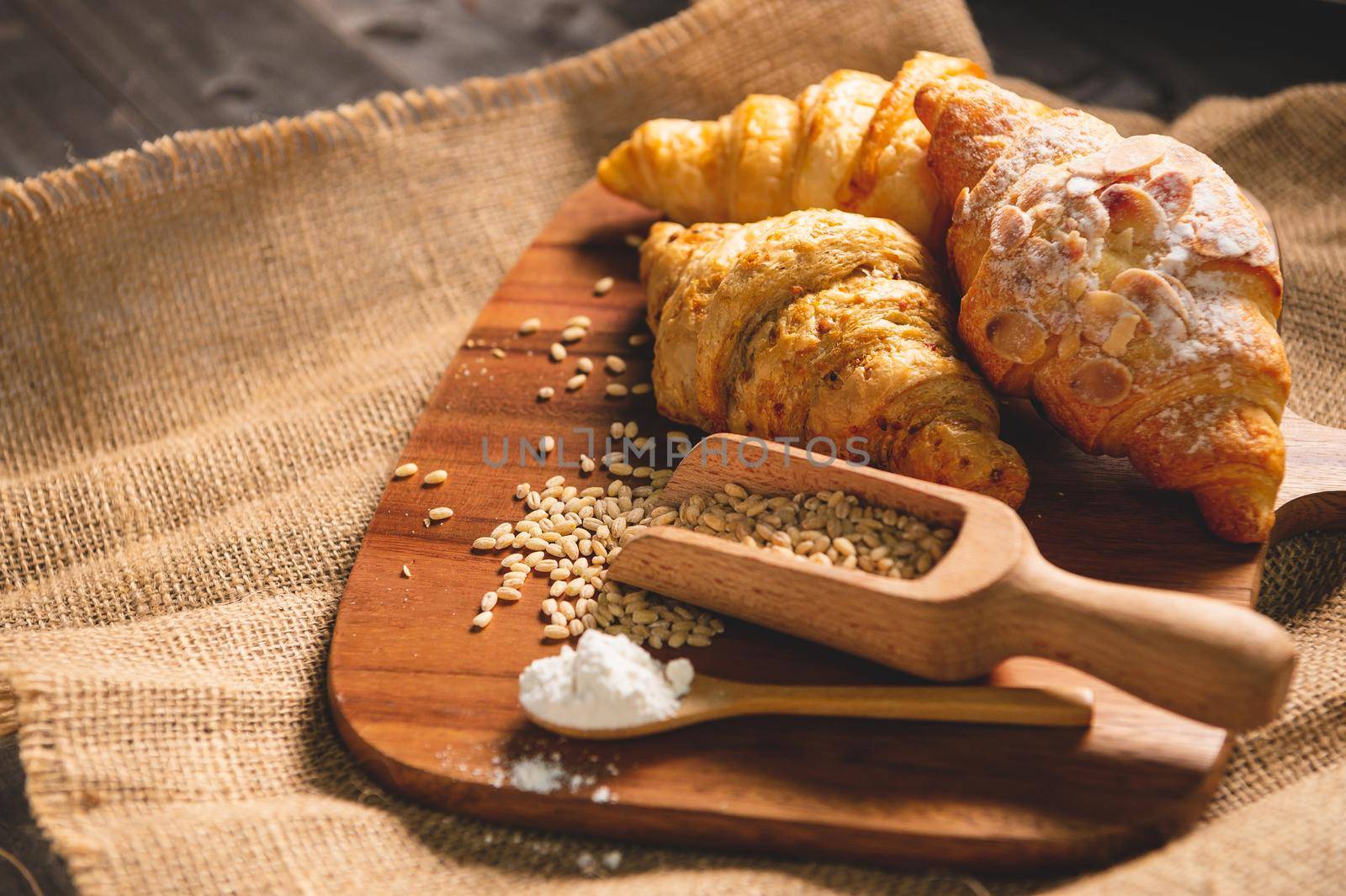 Different kinds of bread with nutrition whole grains on wooden background. Food and bakery in kitchen concept. Delicious breakfast gouemet and meal. Carbohydrate organic food cuisine homemade