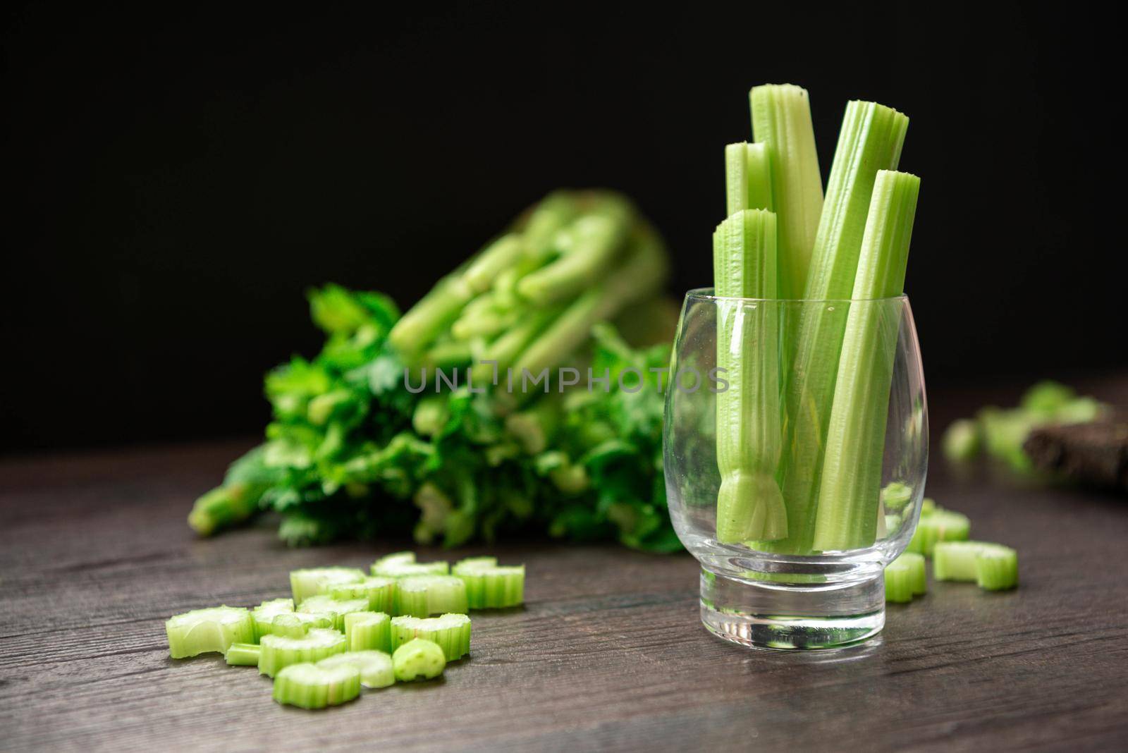 Bunch of fresh celery stalk on wooden table with leaves prepared for making juice. Food and ingredients  of healthy vegetable. Freshness herbal and low calories for dieting with plenty of vitamin