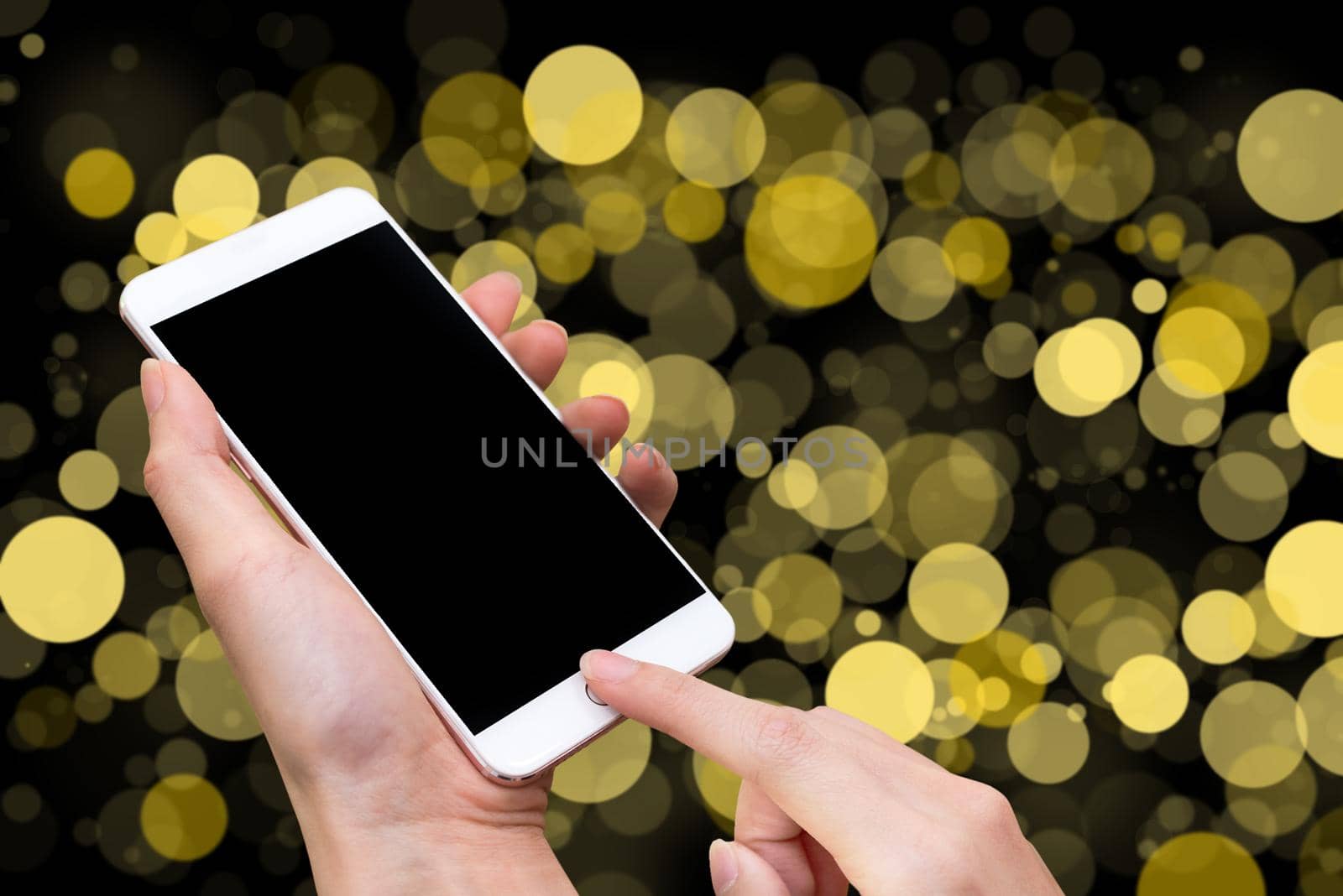 Woman hold smart phone and touch button by hand with blank screen for advertisement, Yellow Bokeh blur and abstract background ,Technology concept