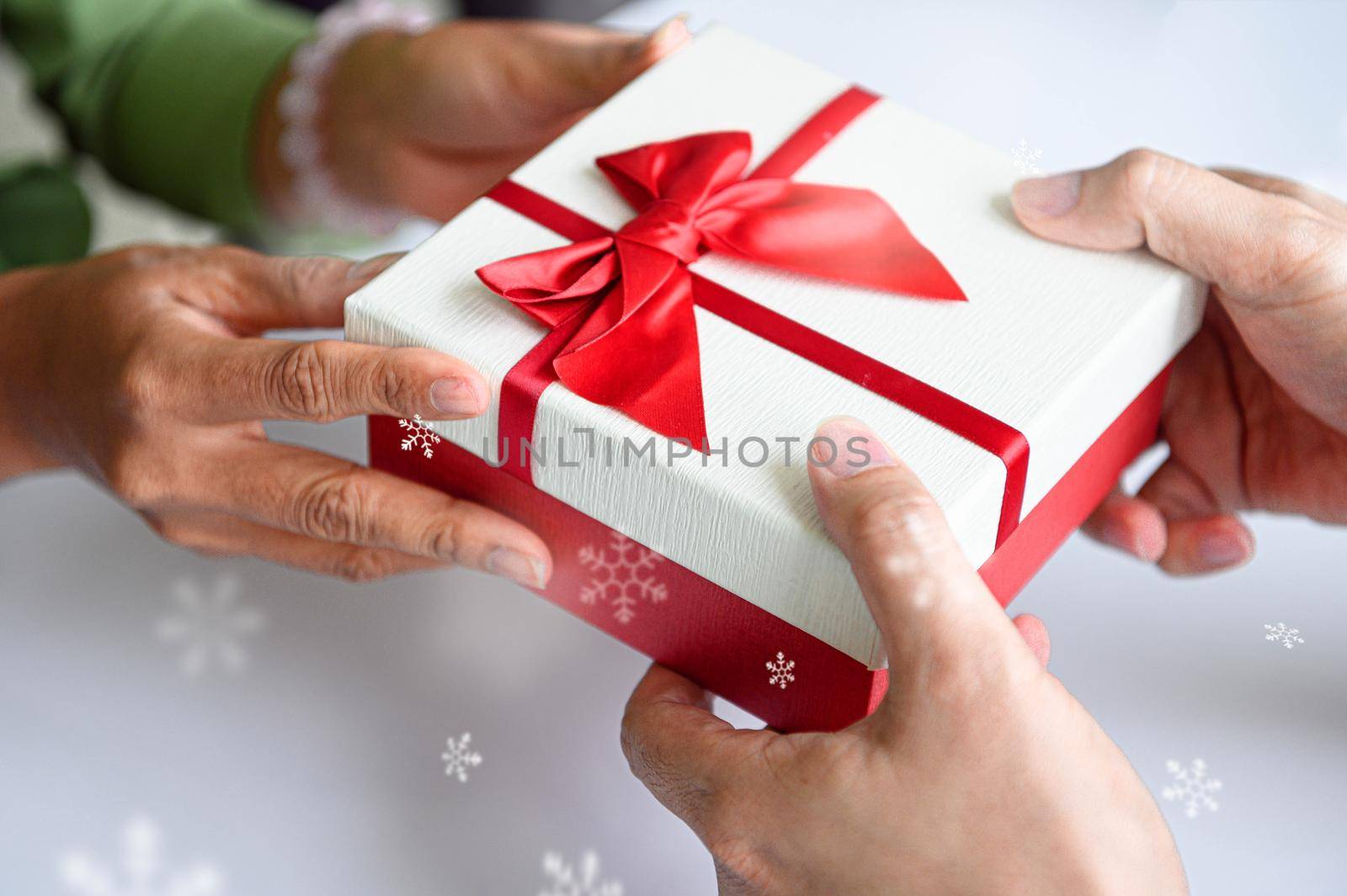 Closeup of hands giving gift box in Christmas day and new year festival to each other. Holiday and event. Surprising giftbox in dating on end year party. People lifestyle and object concept.