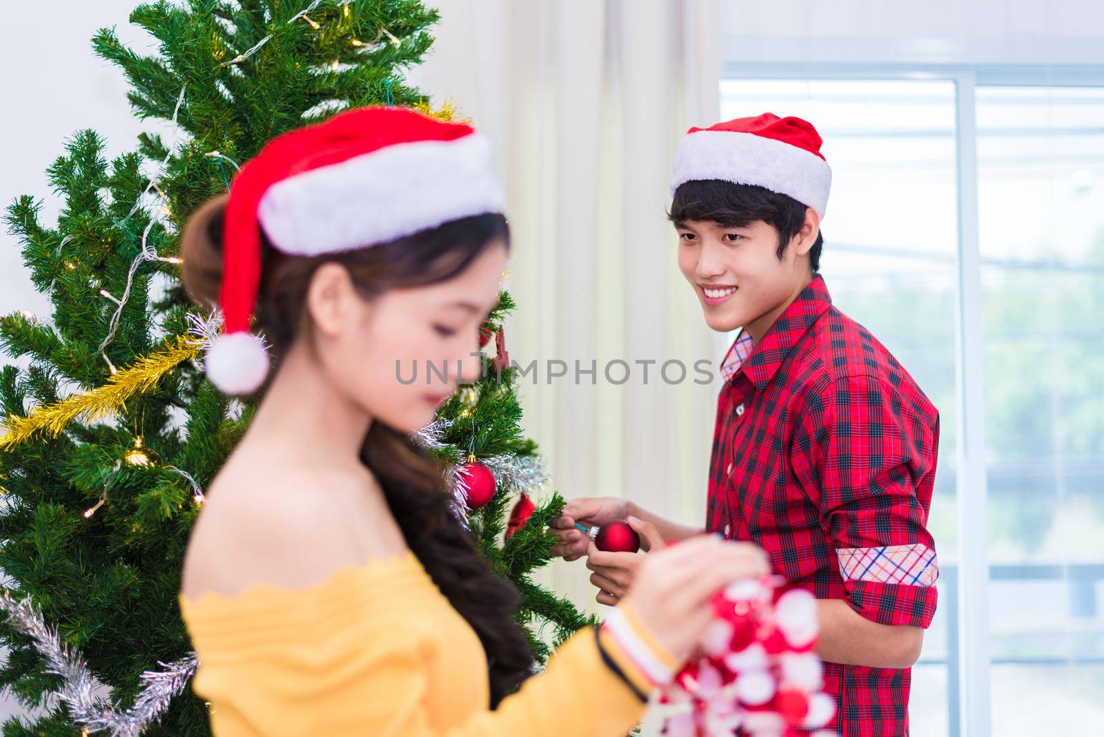 First impression of man to woman who prepare to decorating Christmas tree in New year festival. Xmas and Event concept. Love of Lovers and couples concept. Bed room and living room theme. Fall in love