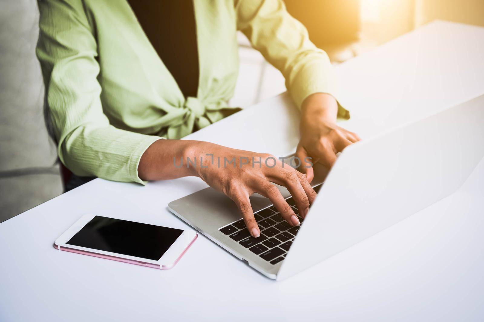 Closeup of woman hand working at home office and typing on keyboard. Business and technology theme. People lifestyles and Office occupation concept. Accounting and Computer freelance programming theme