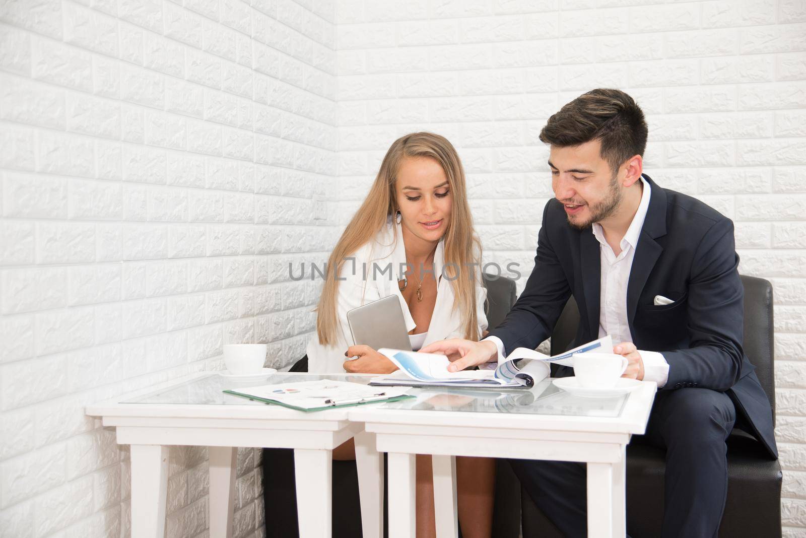 Business man and his secretary talking for annual report of year and profit. Teamwork meeting and Consulting concept. Cooperation and Office theme. Man and woman talking about presentation report
