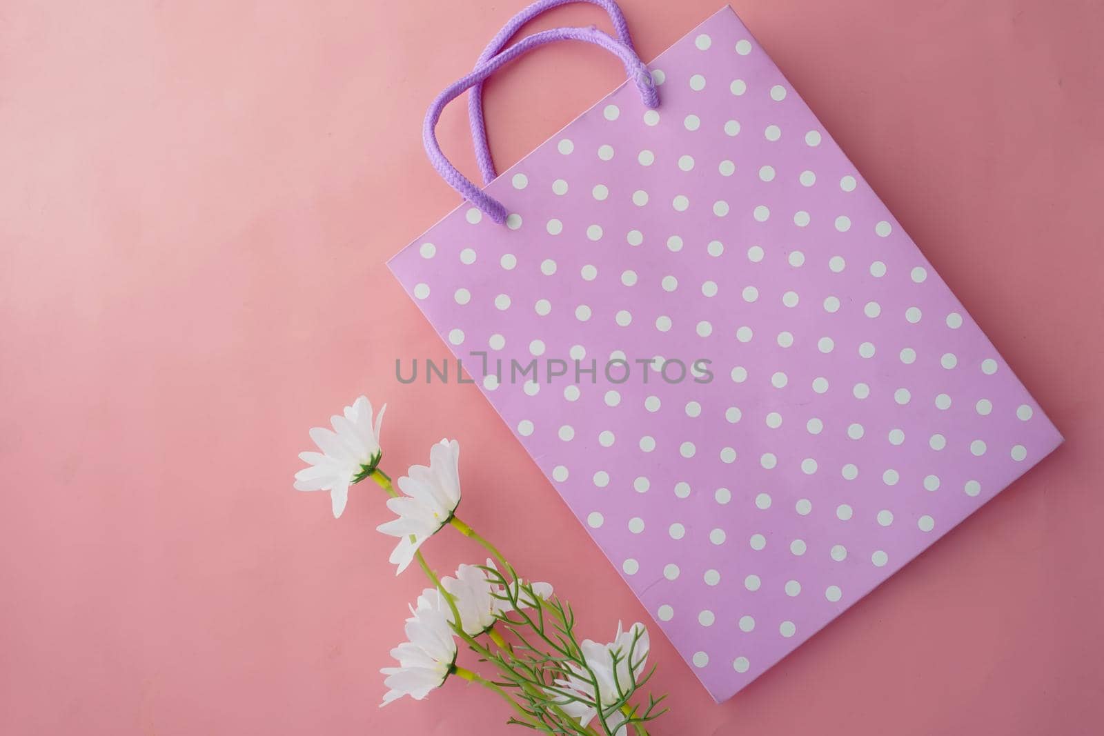 women gift bag on pink background top view
