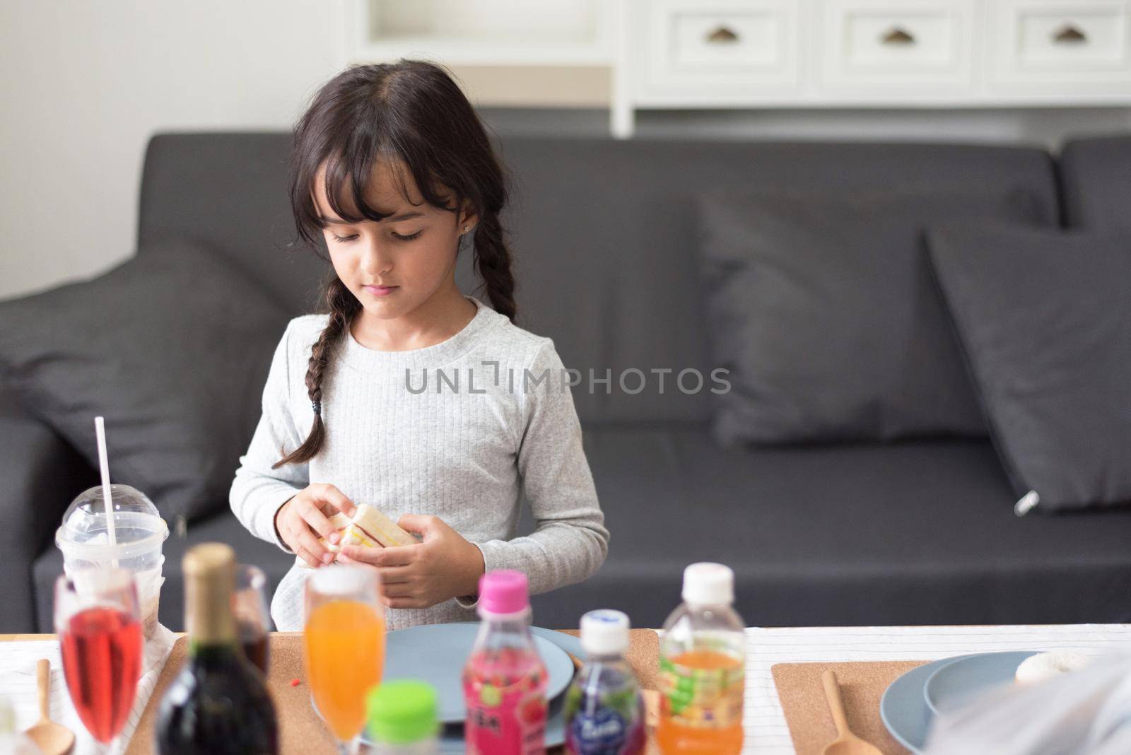 Happy little girl preparing to cook with toy as chef in living room. Playful of child and happiness education and development concept. Learning and leisure of cute girl. Nursery and daycare theme.