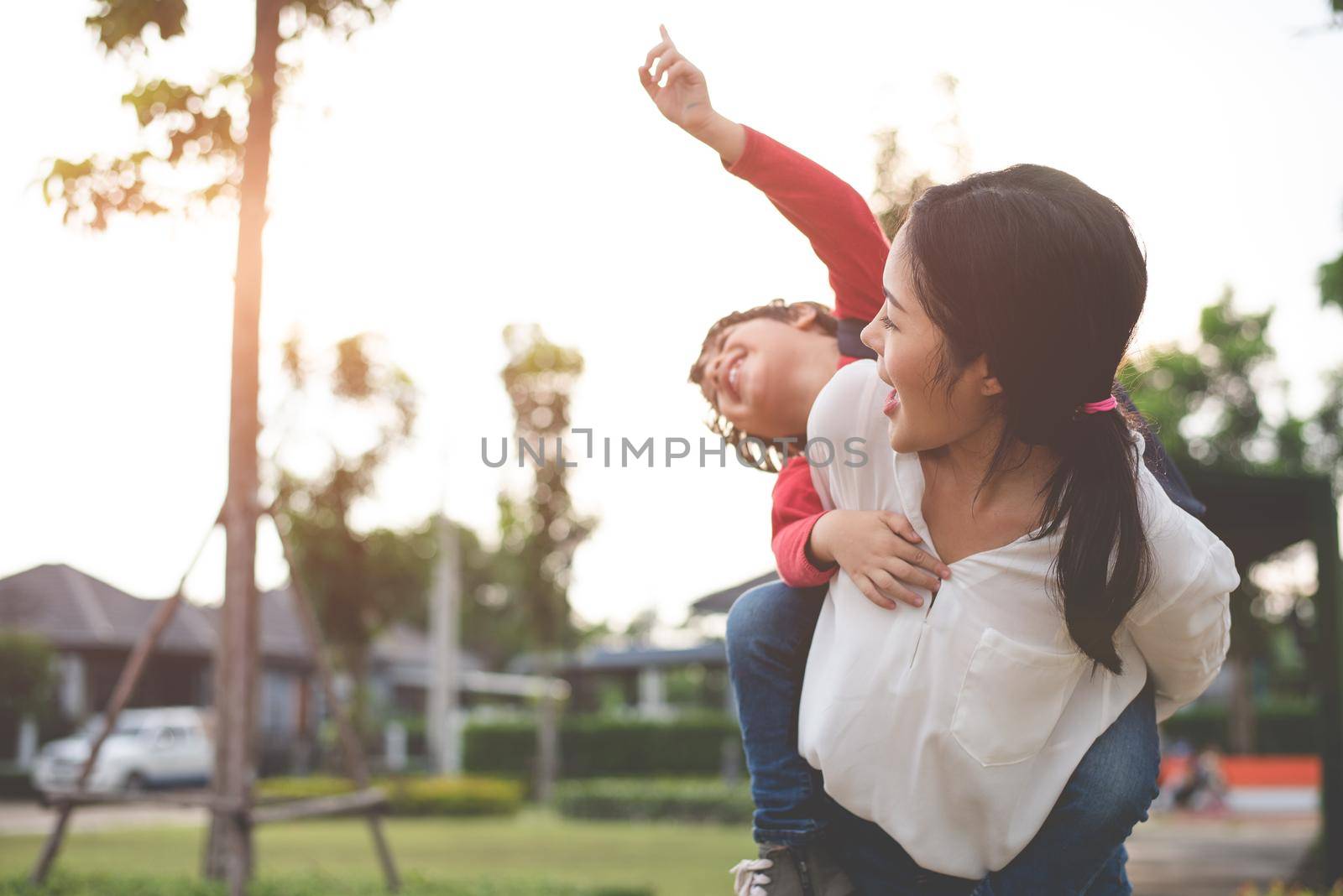 Mom hug and carry her son. Preparing to send her children back to school in morning. Education and Back to school concept. Happy family and Loving of people theme