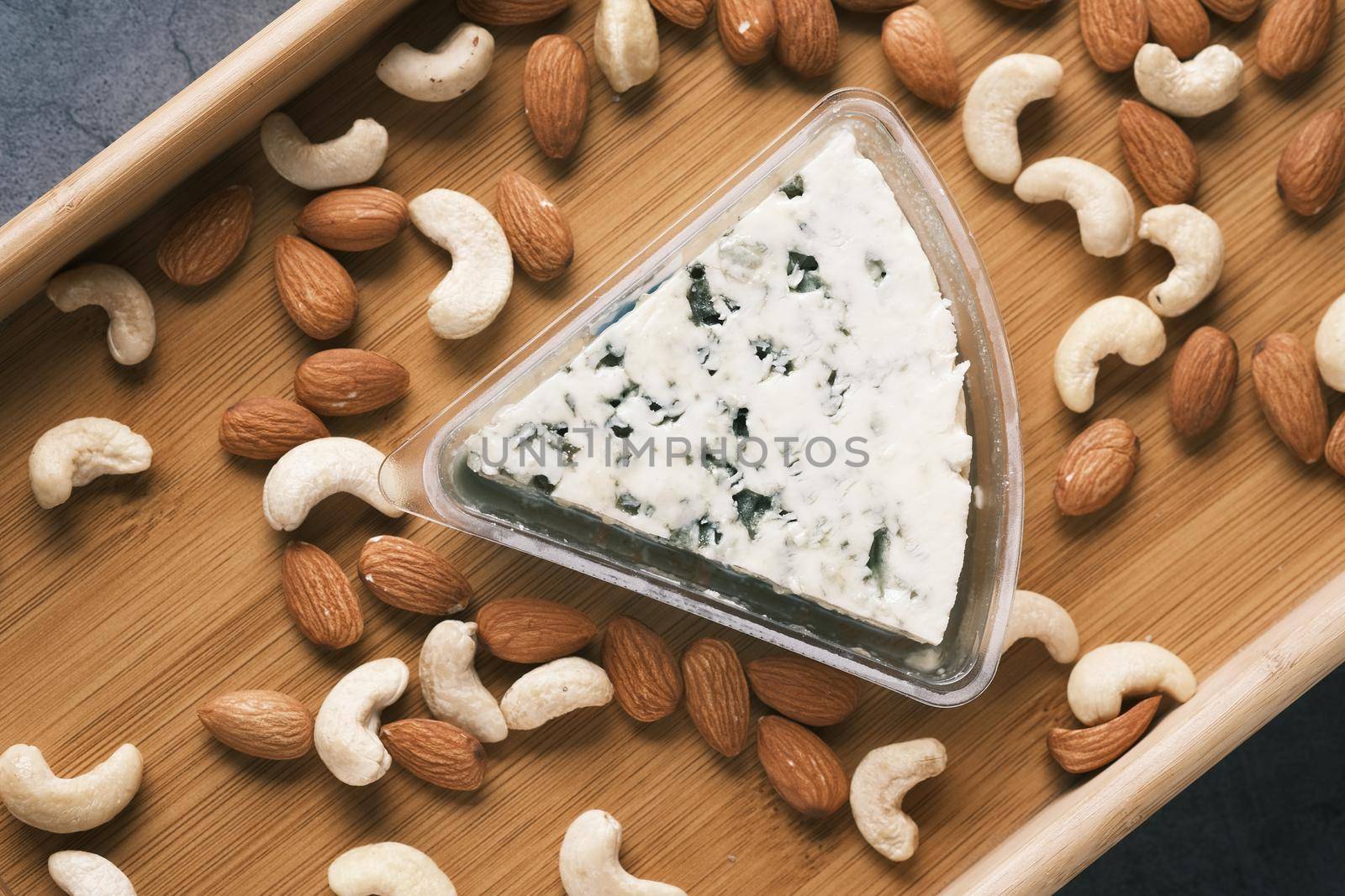 close up of fresh cheese , cashed and almond nut on table by towfiq007