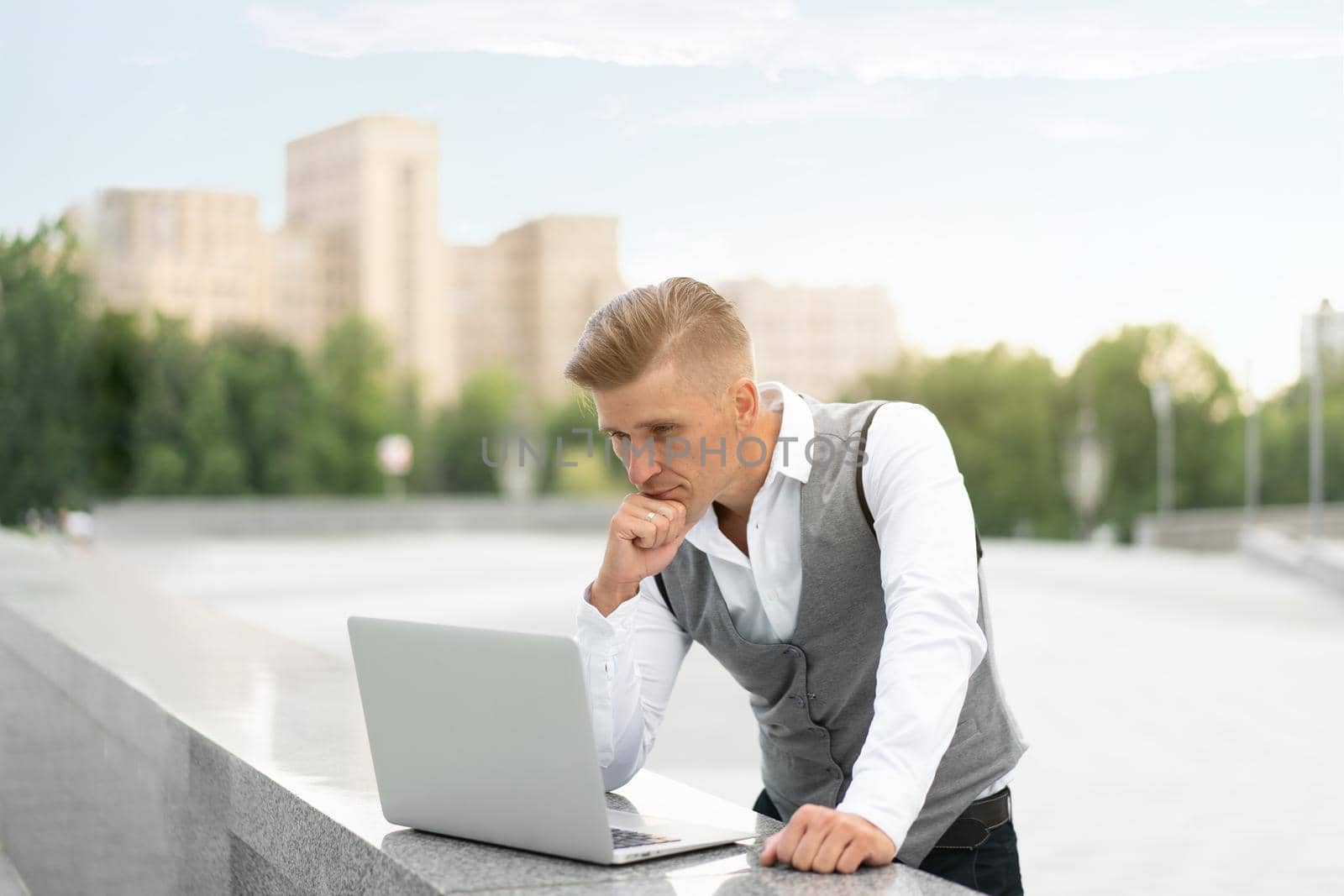 Business. Businessman Using Laptop Outdoors. Serious Pensive Caucasian Male Business Person Computer Outside Modern Technology Concept Young Adult Manager Crisis Thinking Trouble Idea