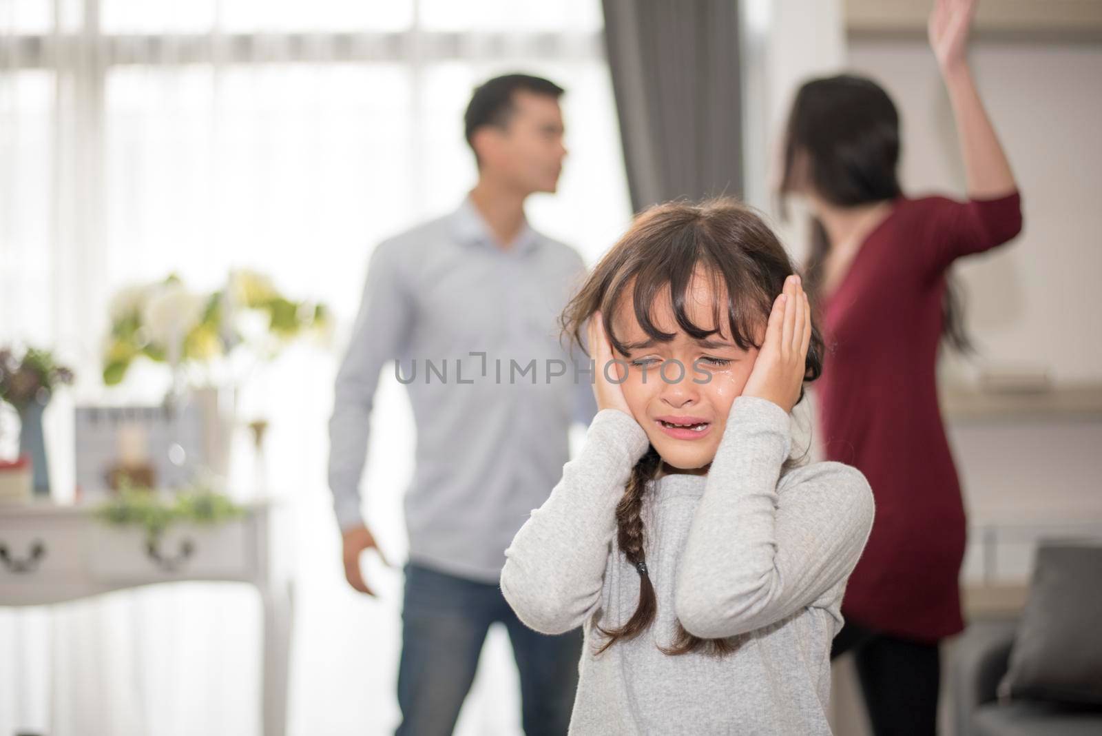 Little girl was crying because dad and mom quarrel, Sad and dramatic scene, Family issued, Children's Rights abused in Early Childhood Education and Social and parrents care problem concept by MiniStocker