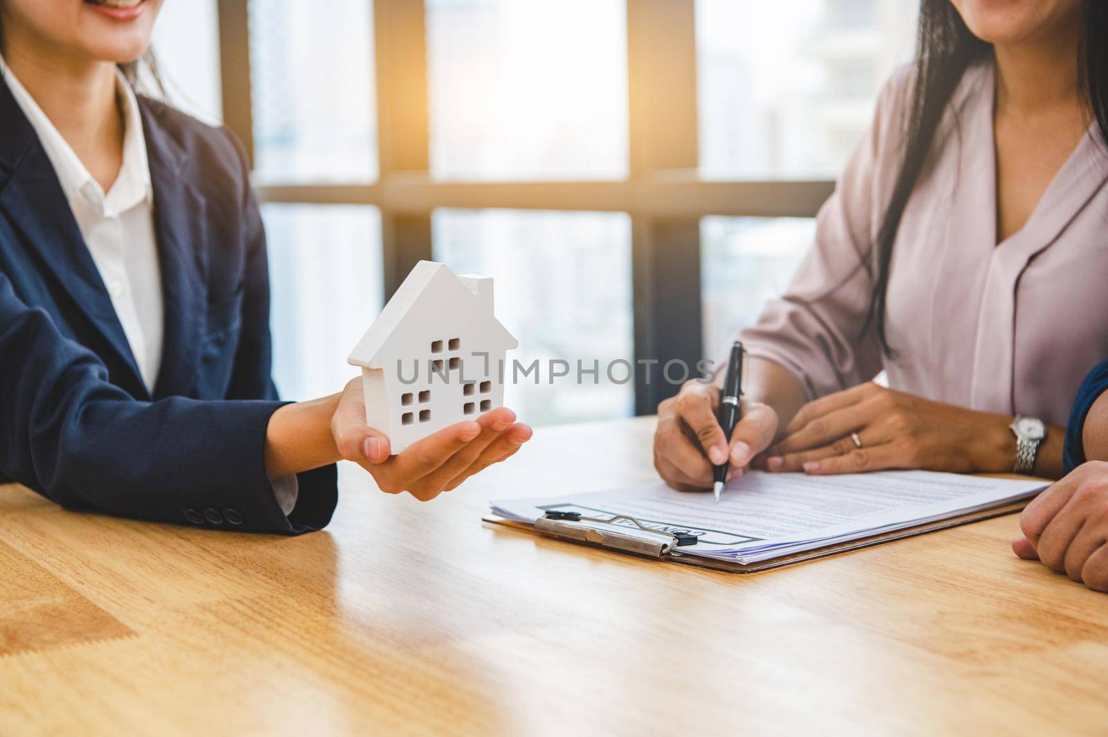 Real estate broker agent offer private home to customer before sign contract agreement documents for rental house property. Ownership realty purchase. Mortgage loan approval concept. Money investment