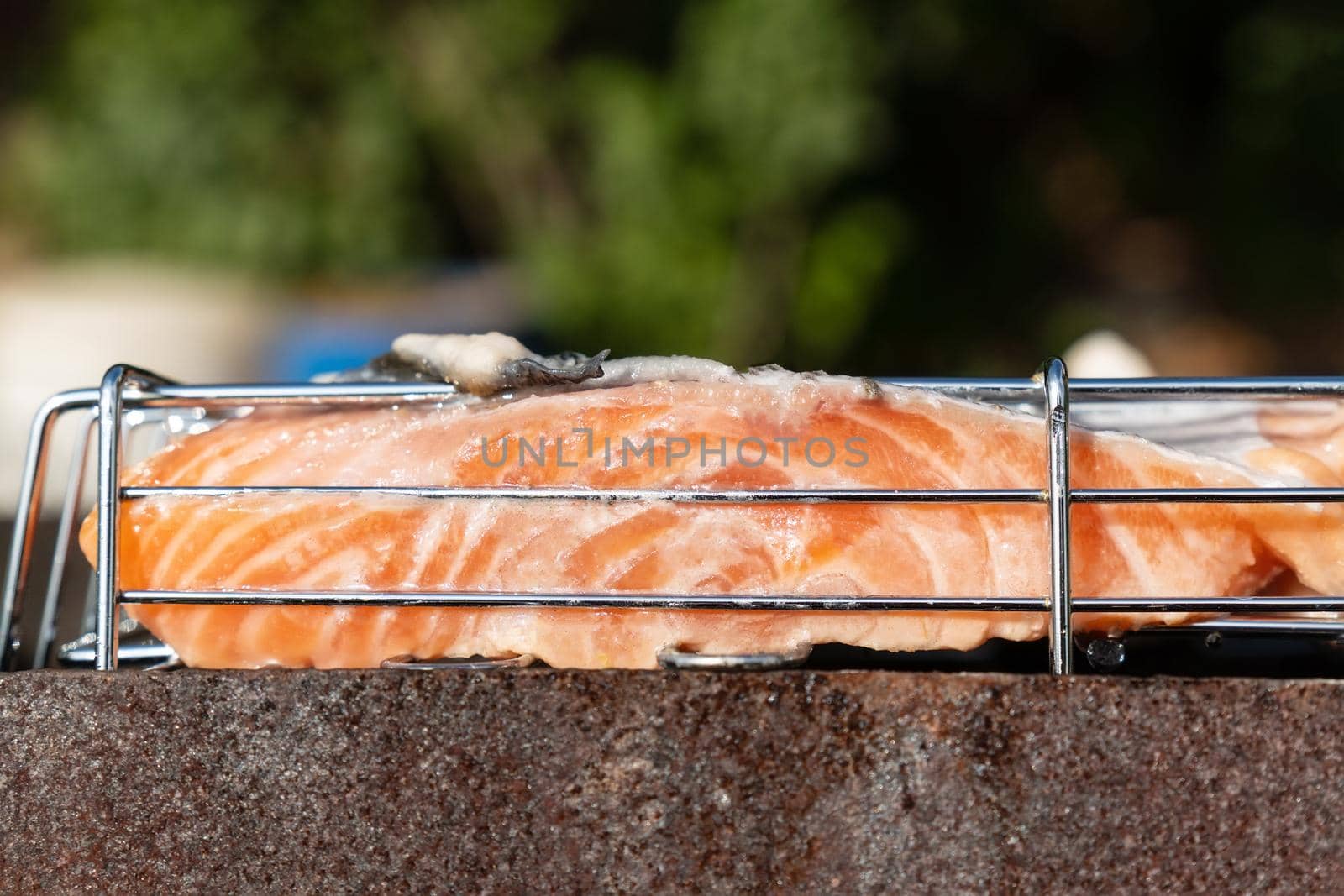 Grilled salmon fish close-up on a flaming grill. Selective focus