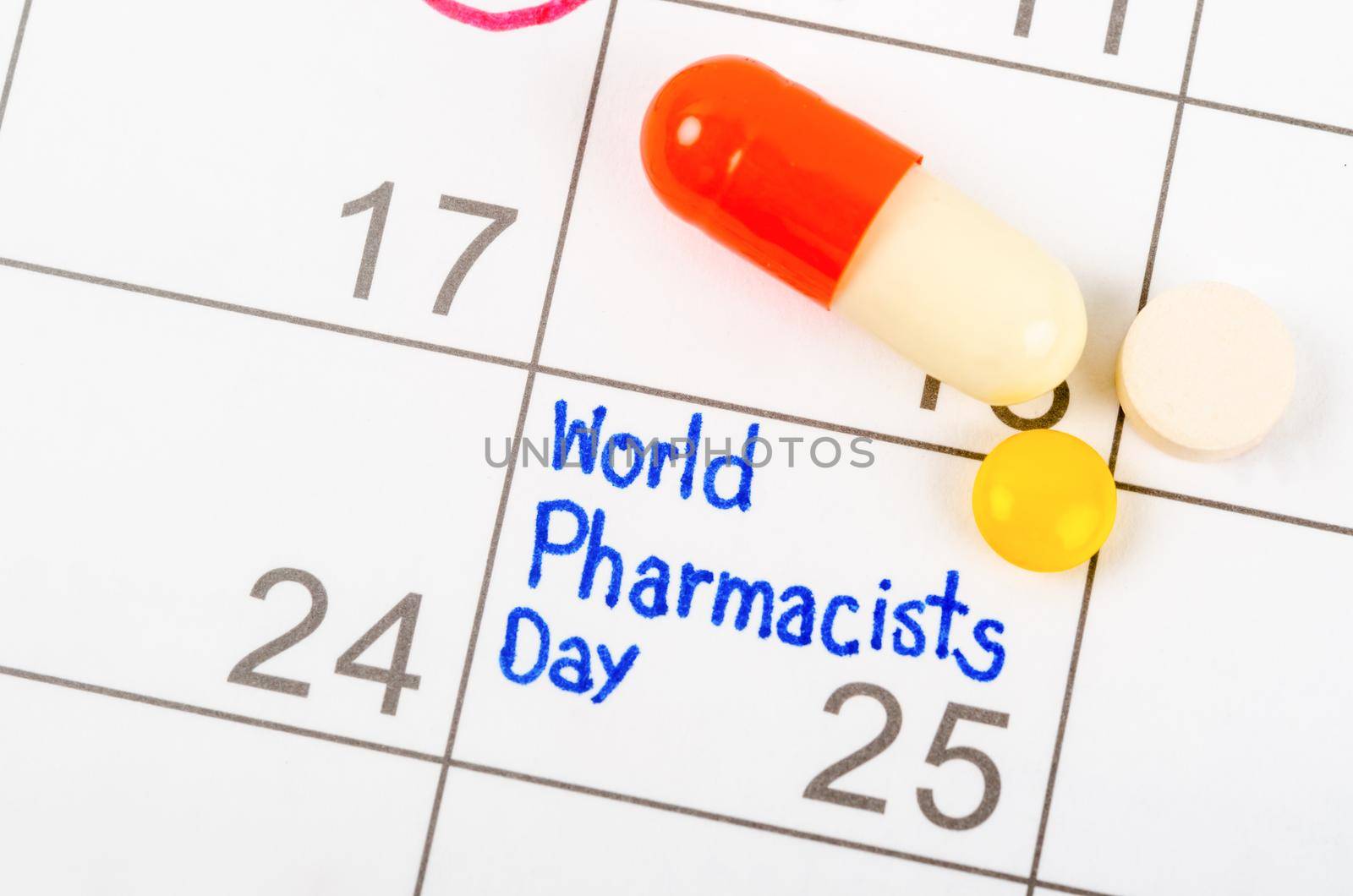 The words World Pharmacist Day written in calendar September 25 page and medicine to remind you an important appointment.