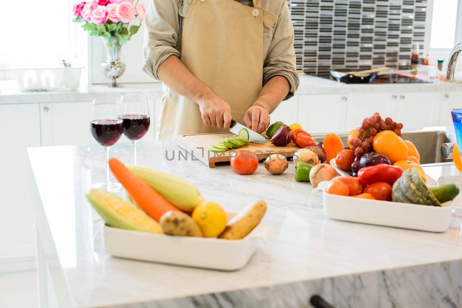 Man cooking and slicing vegetable in the kitchen. People and lifestyles concept. Food and drink theme.