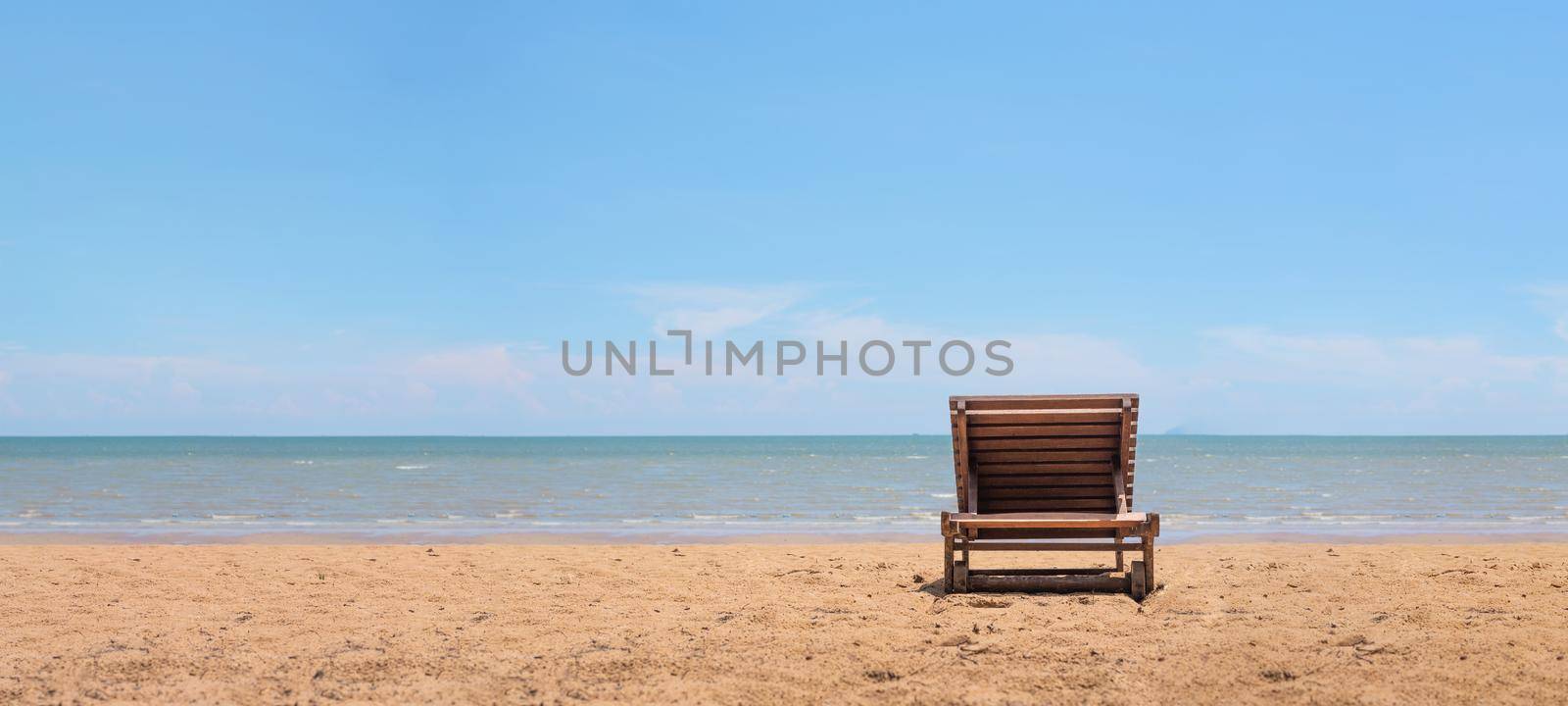 Sunbath chair on the beach with clearly blue sky background. Relax and vacation concept. object theme. by MiniStocker