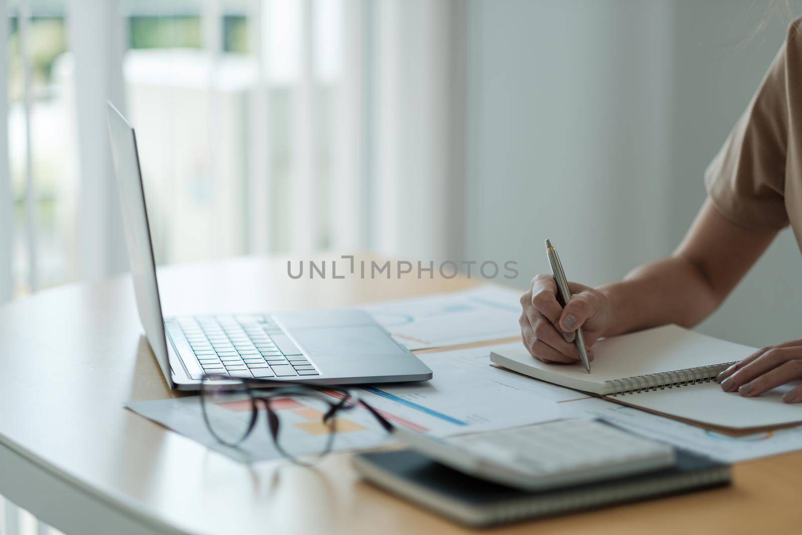 accountant woman working audit and calculating expense financial annual financial report balance sheet statement, doing finance making notes on paper checking document