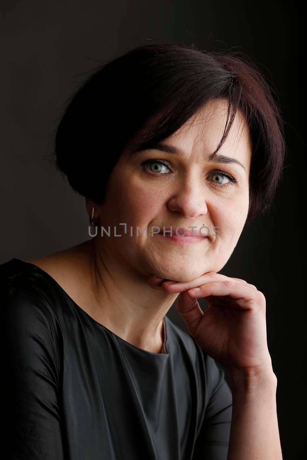 Portrait of a beautiful middle-aged woman. European style blue eyed brunette