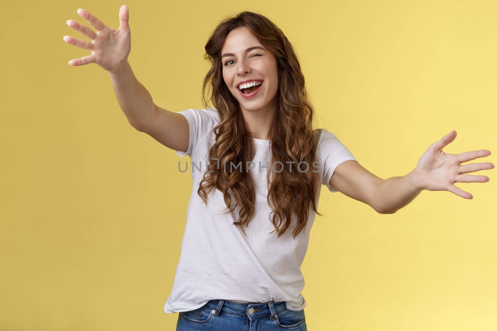 Girl cheering up sad friend wanna comfort girlfriend winking upbeat optimistic attitude extend arms towards camera cuddling reaching you give hug embracing guest smiling broadly invite come in by Benzoix