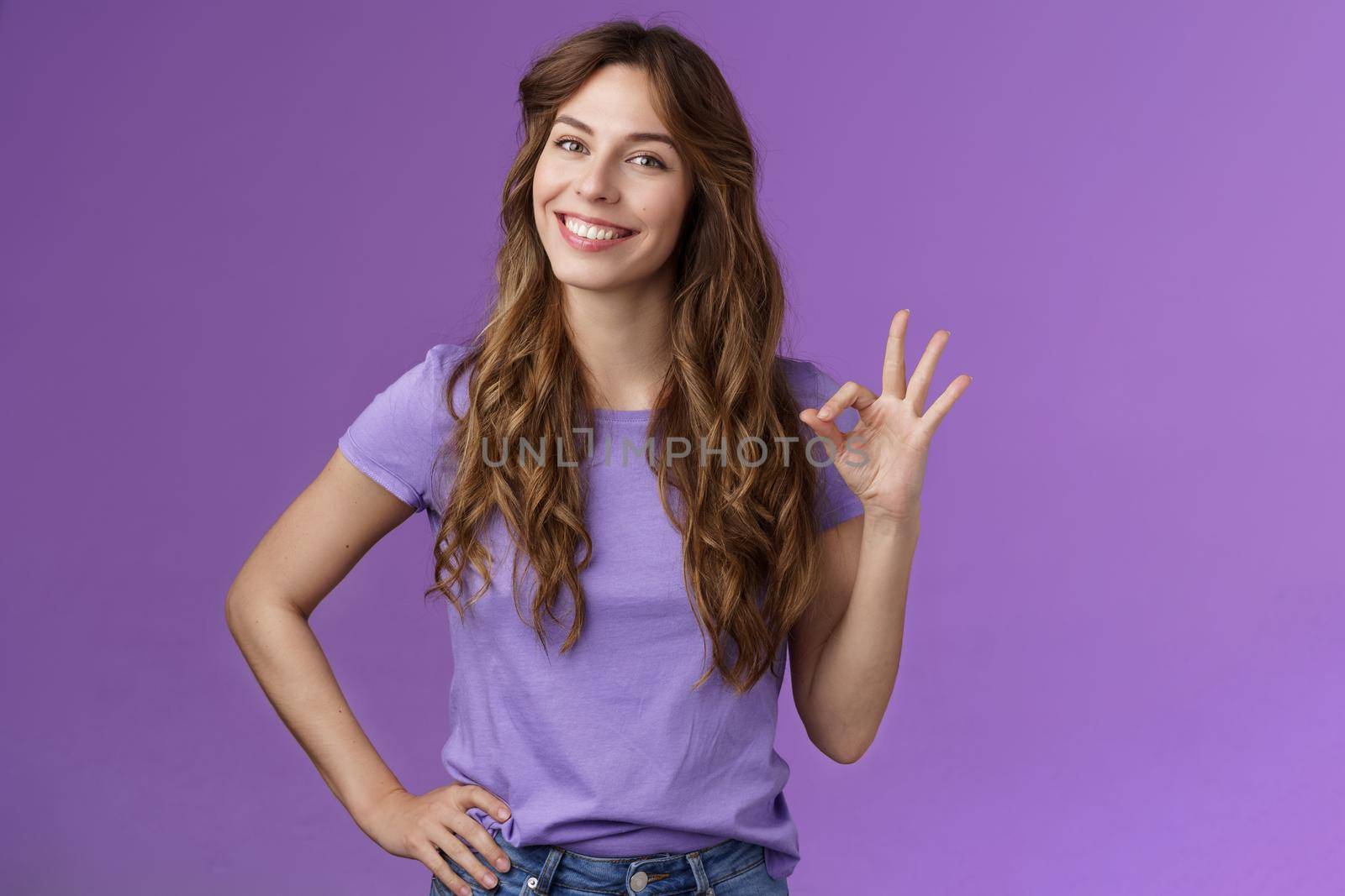 Confident professional girl not scared difficult task assure everything okay smiling broadly self-assured pose hold hand hip show ok ring sign grinning accepting agree good terms purple background by Benzoix