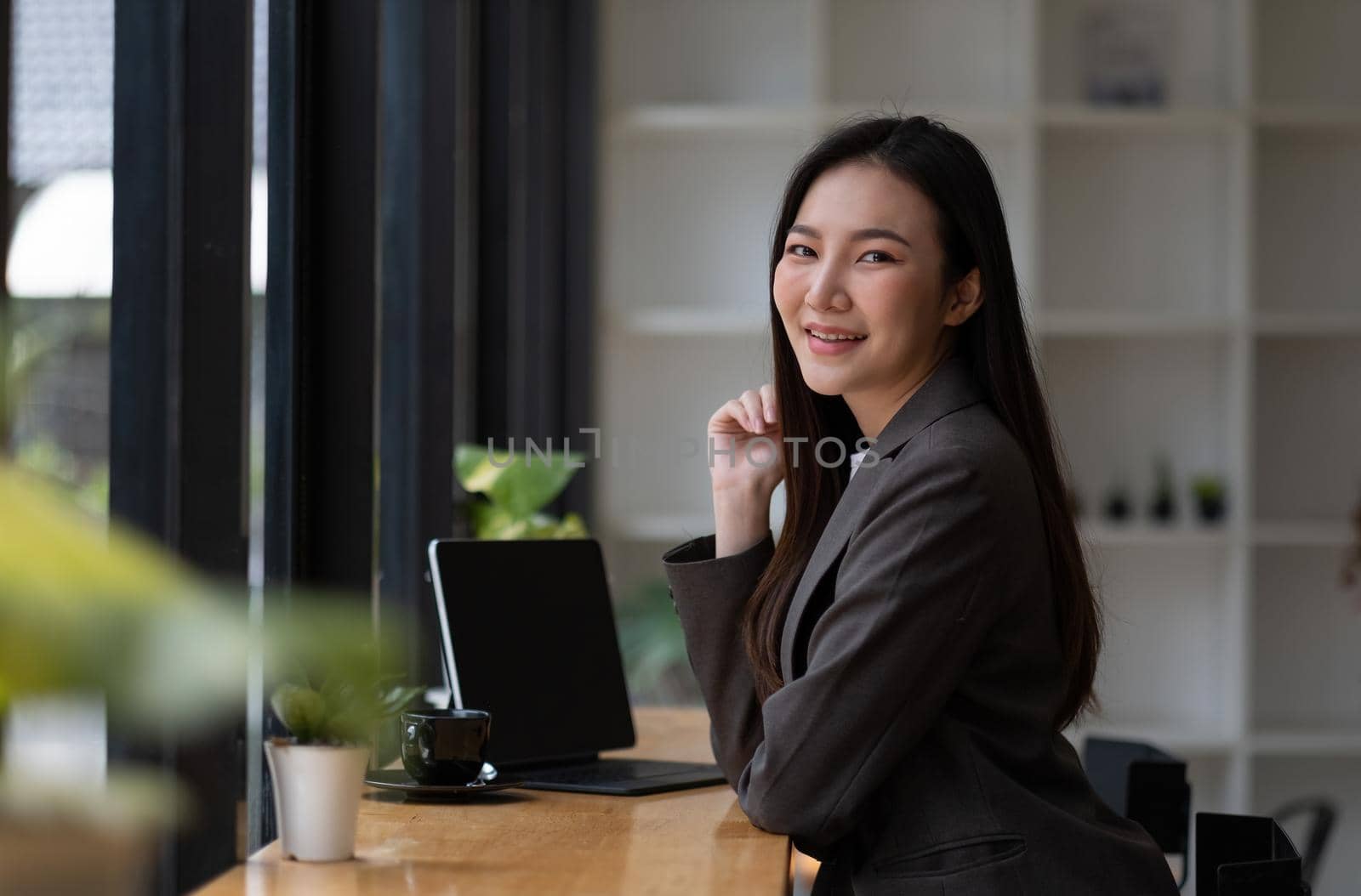 Portrait of smiling beautiful business asian woman working in modern office desk using tablet laptop computer, Business people employee freelance online marketing e-commerce telemarketing concept.