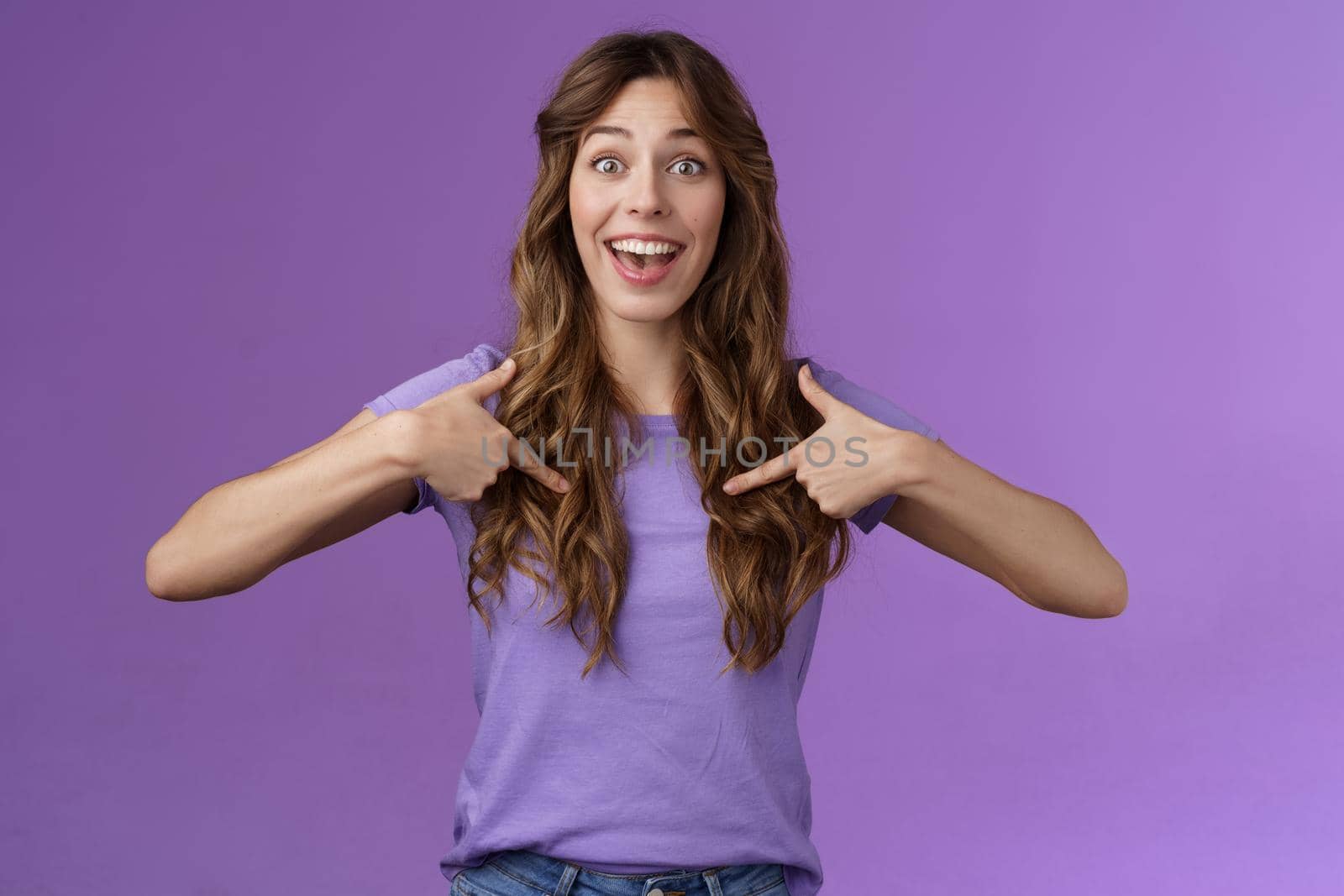 Cheerful lively upbeat entertained happy girl curly hairstyle open mouth amused pointing center herself happily tell own achievement smiling broadly telling friends promotion purple background by Benzoix