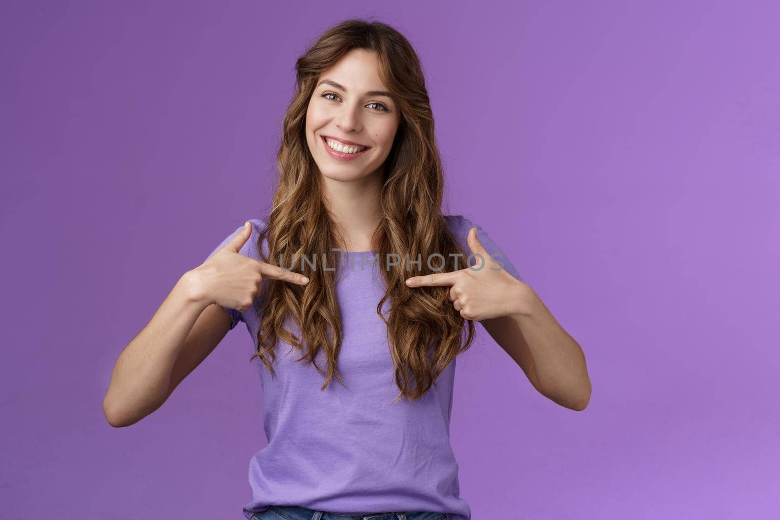 Cheerful motivated professional assertive curly woman pointing herself center smiling broadly propose own help wanna participate boastful talking accomplishments stand purple background by Benzoix