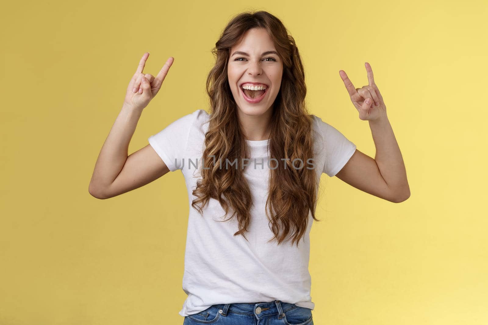 Girl having fun excellent awesome concert enjoy live music show rock-n-roll heavy metal gesture yelling upbeat happy attend cool festival party smiling broadly show tongue daring yellow background by Benzoix