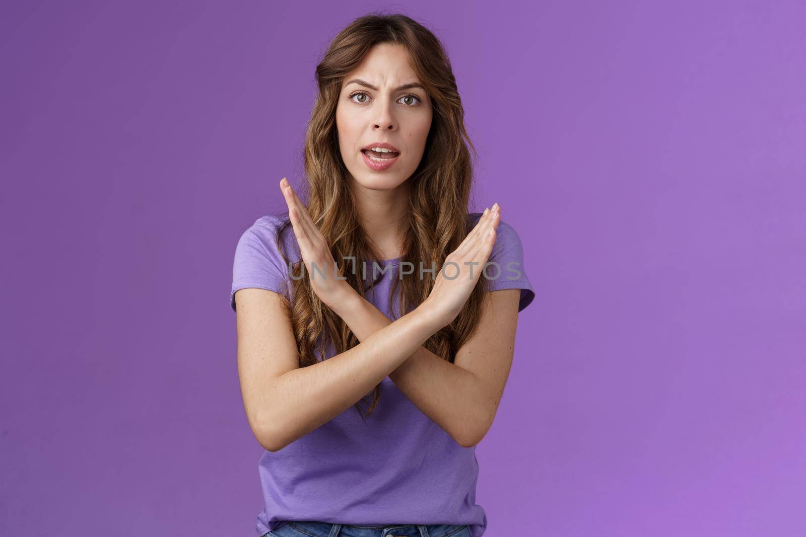 Quit fooling around. Serious-looking woman bad mood bossy angry make cross fighting lgbtq rights demand stop discrimination forbidding cruel behaviour say no purple background.