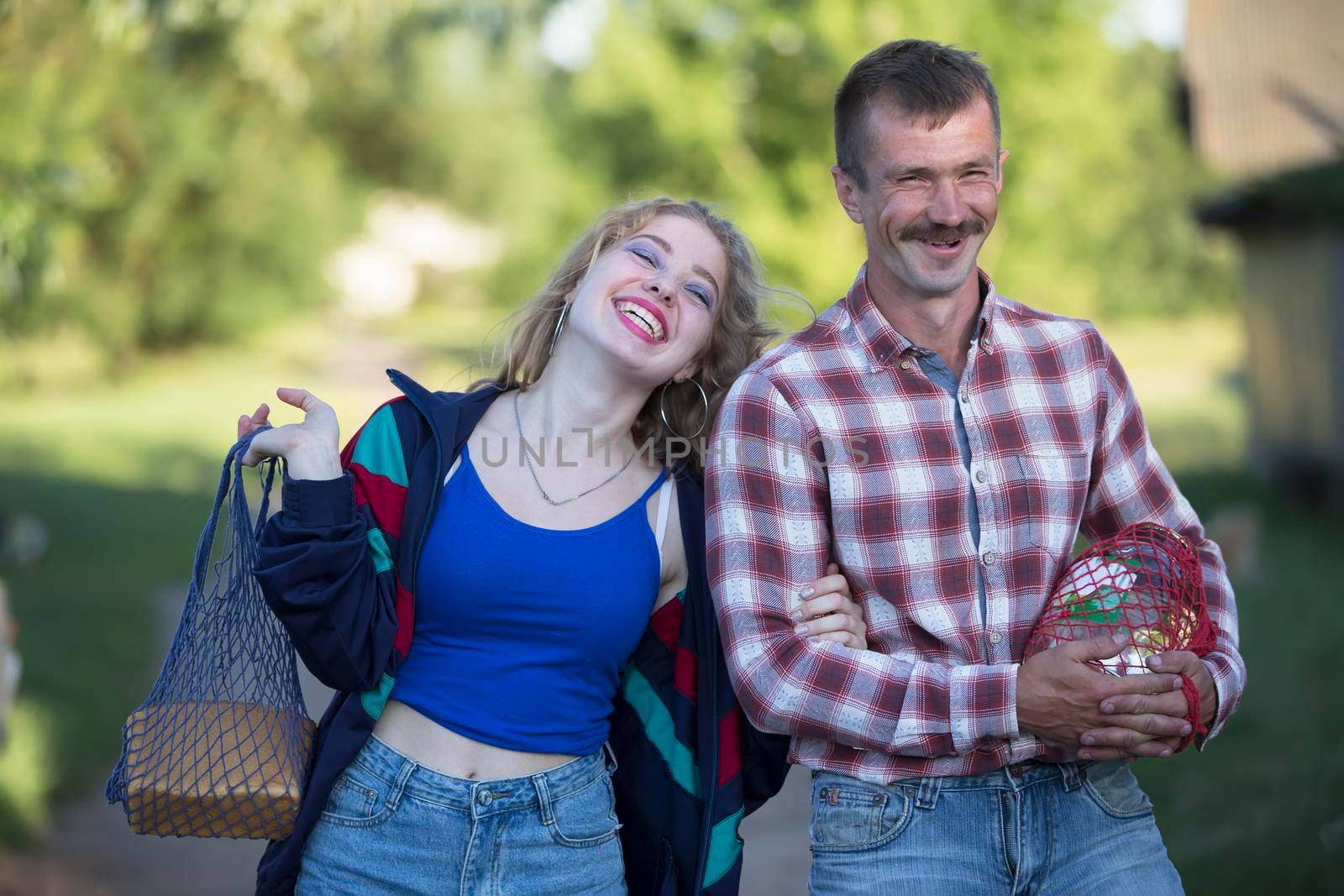 Funny village couple man and woman laughing cheerfully.