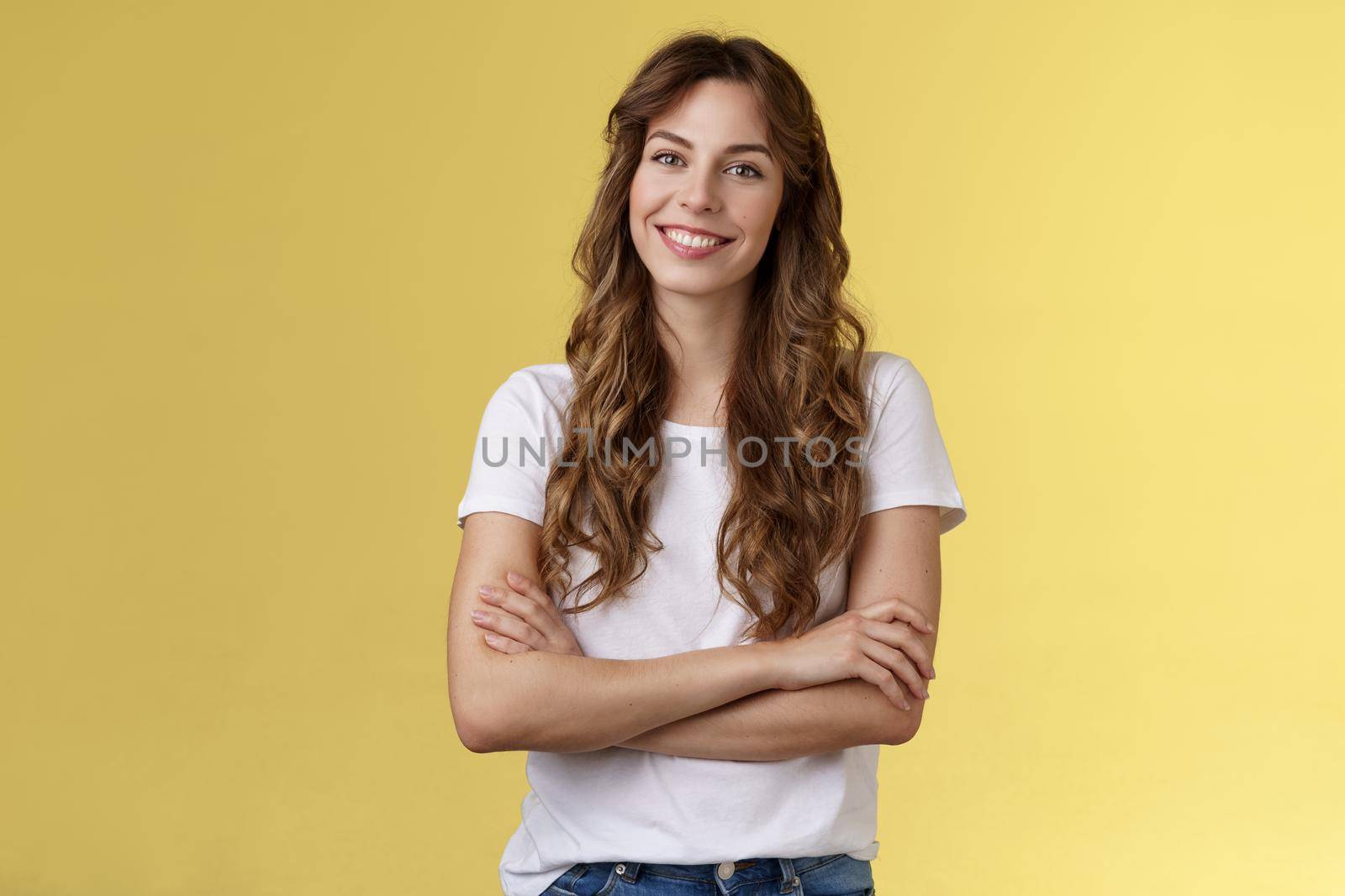 Confident carefree lively smiling female freelancer professional cross arms chest self-assured pose stand comfortable white t-shirt grinning toothy delighted stand yellow background friendly.