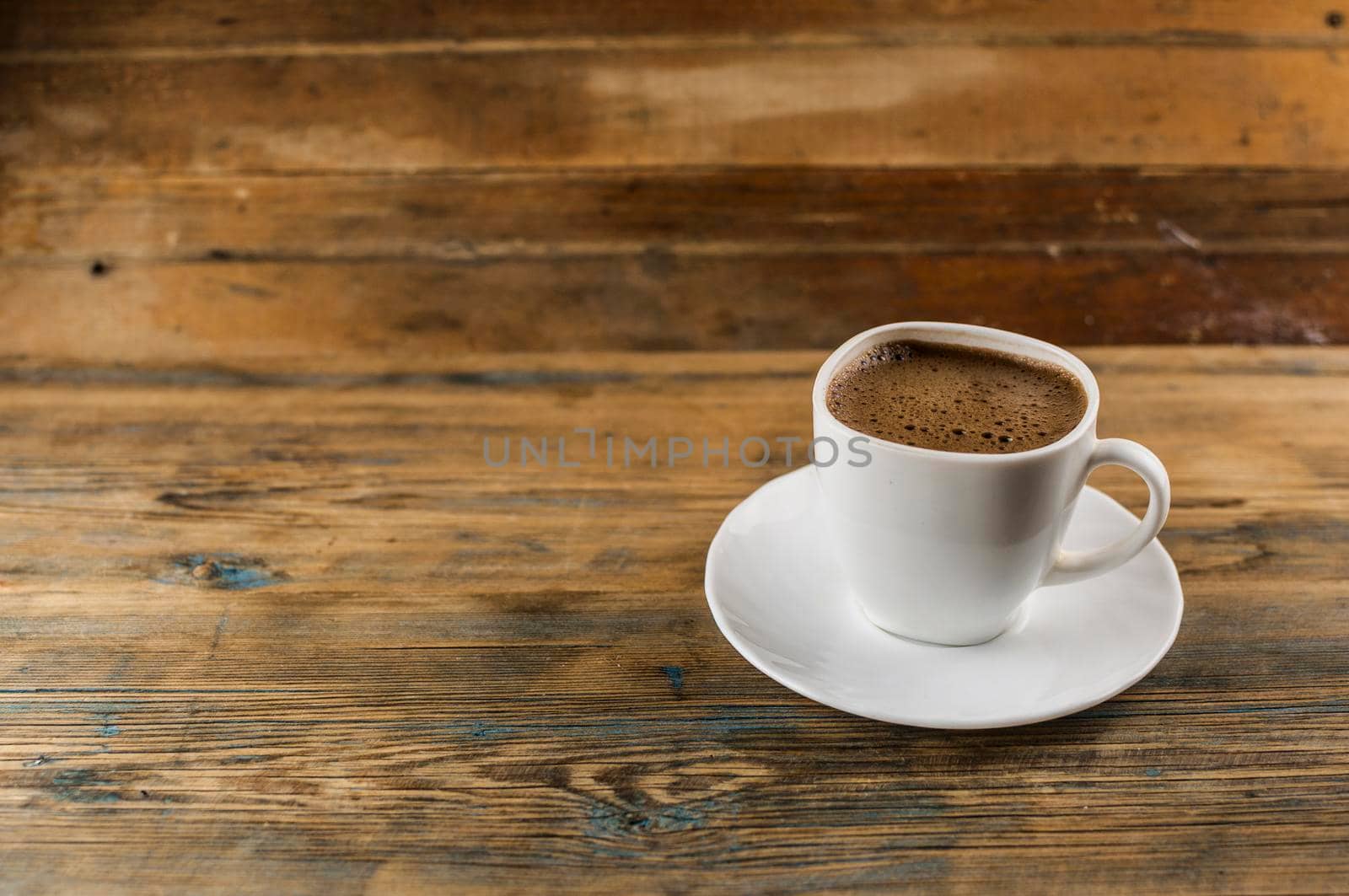 Cup of coffee on a wooden table.