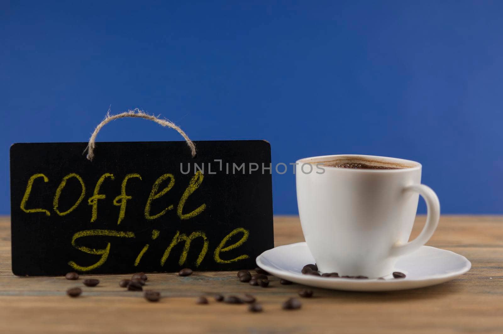 A cup of coffee and blackboard with inscription "coffee time". Coffee break, morning awakening concept.